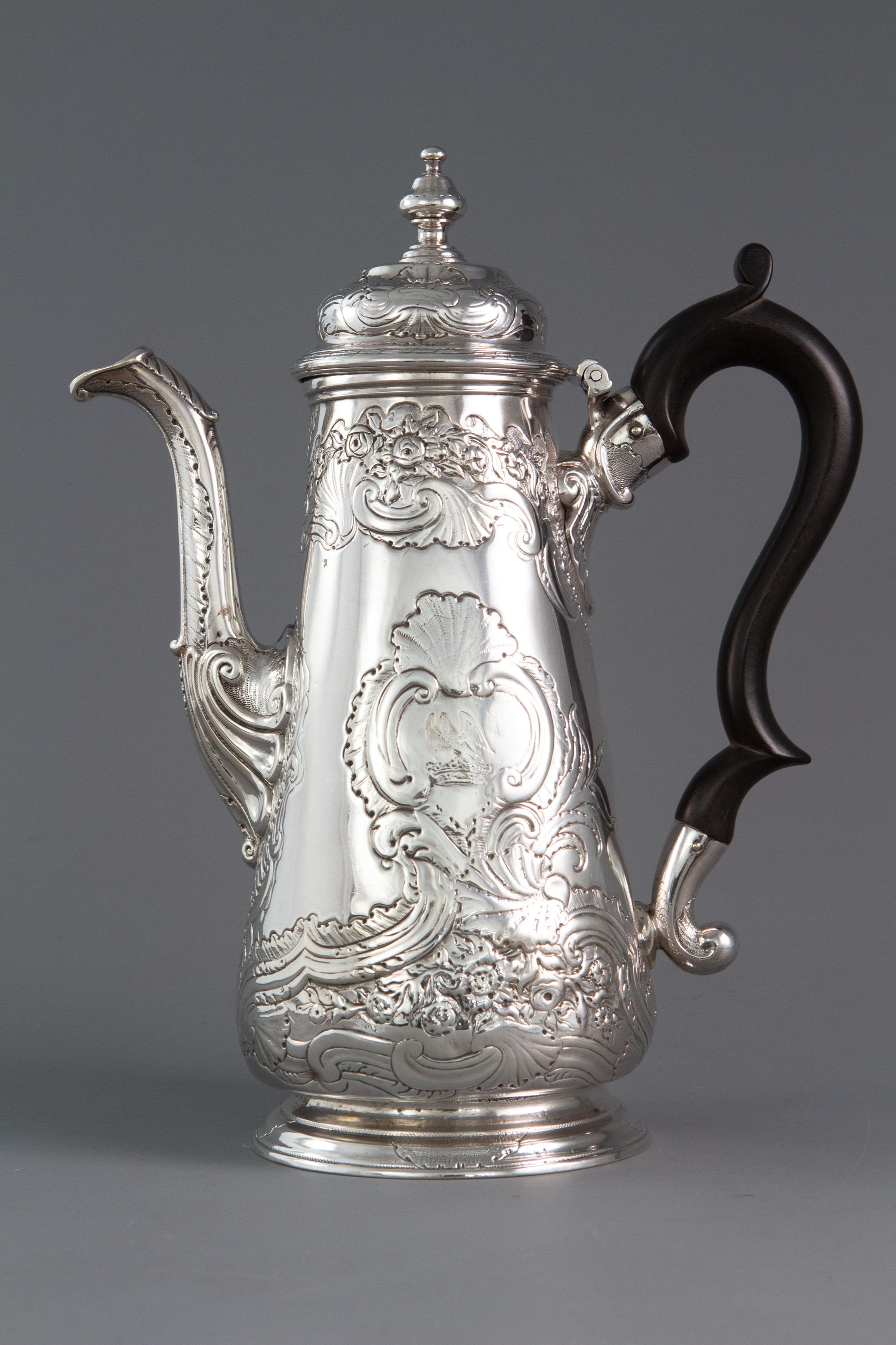 A George II silver coffee pot London 1738 by Christian Hillan

An early Georgian silver coffee pot of baluster form decorated with shell and scroll design with floral motifs. The stepped dome lid with an acorn finial. The leaf-capped swan neck
