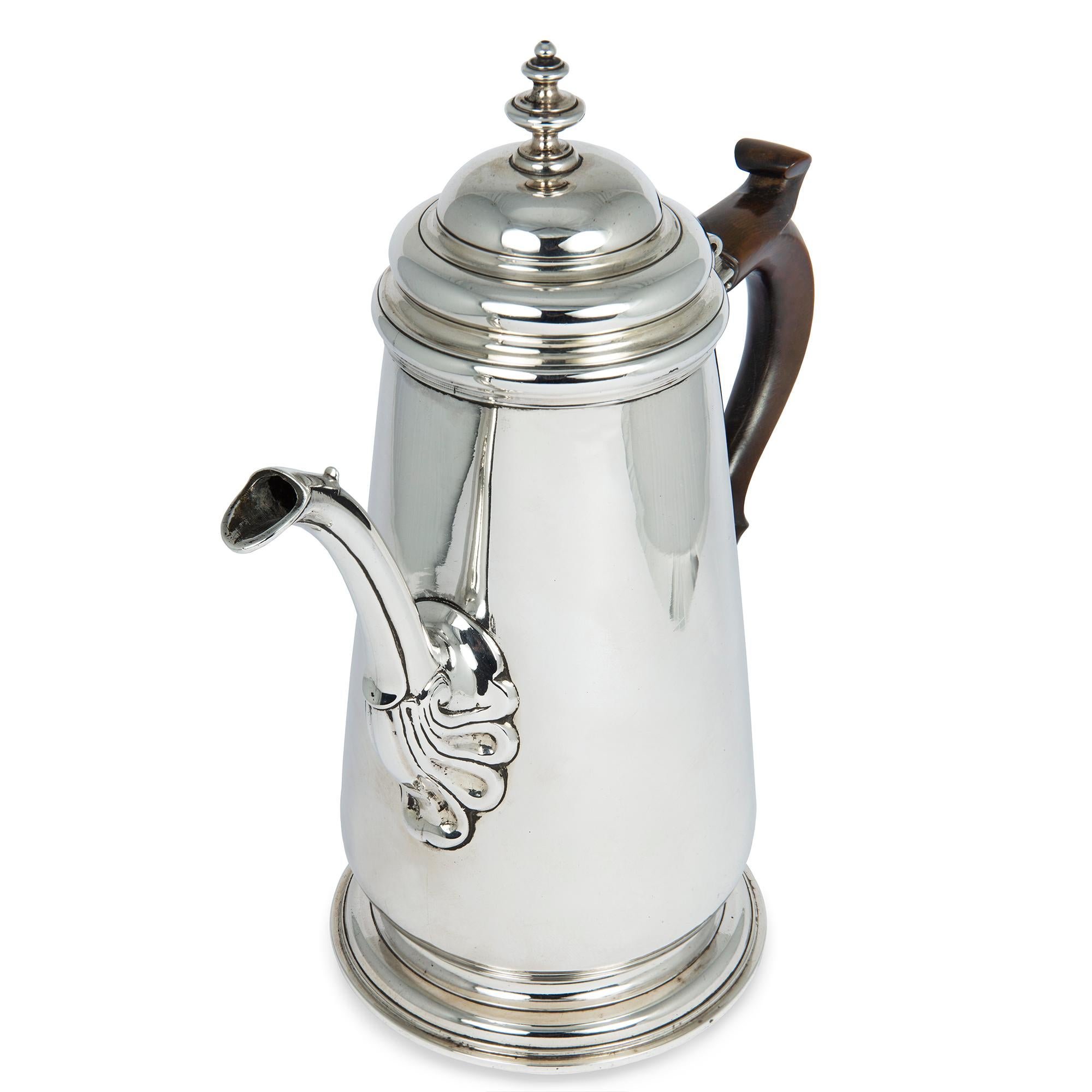 A George II sterling silver coffee pot, the baluster shape body with acanthus leaf decoration to the base of the spout, dark wood scroll handle, height 10