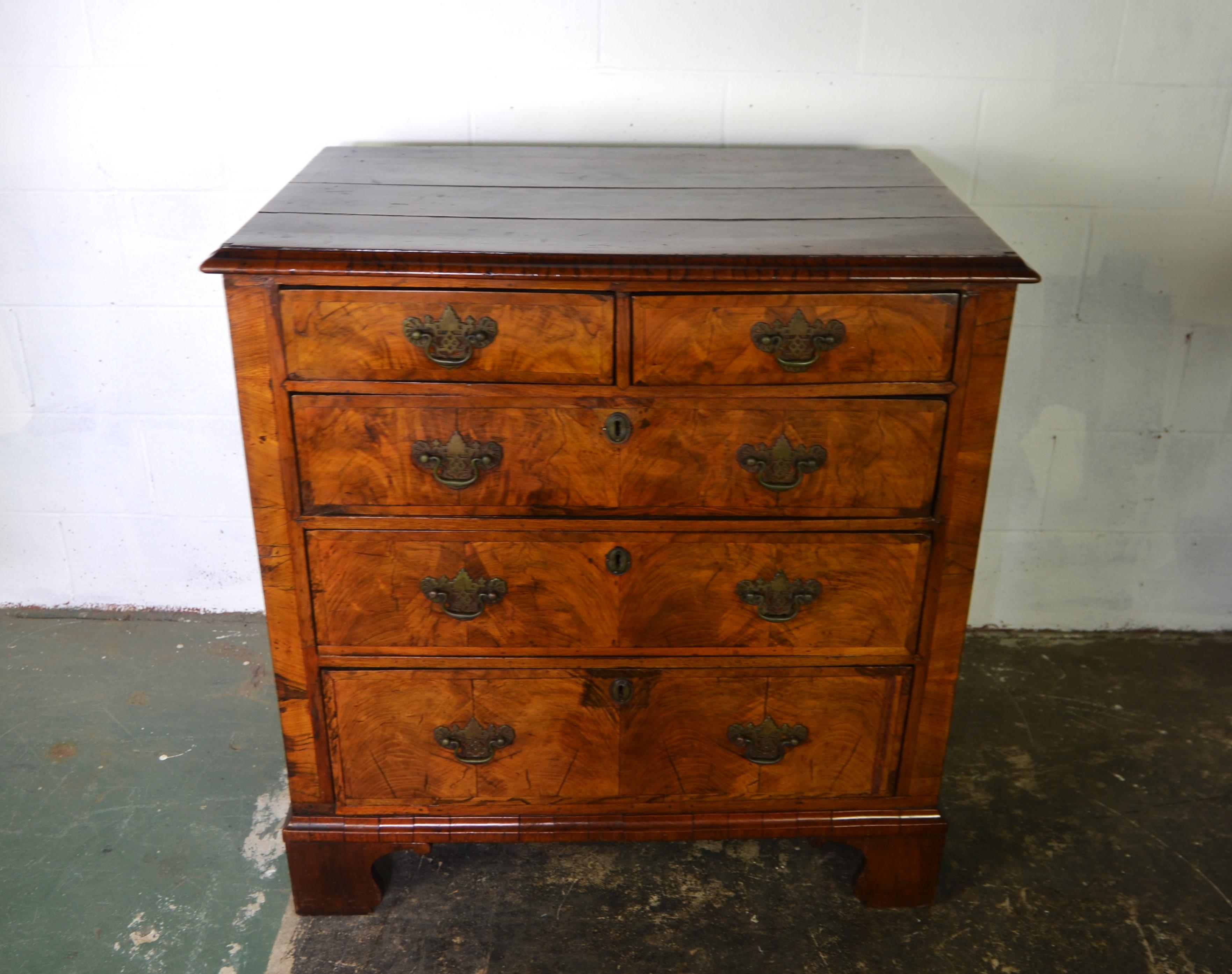 A  George II Walnut Chest of Drawers with nice proportions.  Cross-banded top and drawers. Oak drawer liners. Bracket feet  c.1835