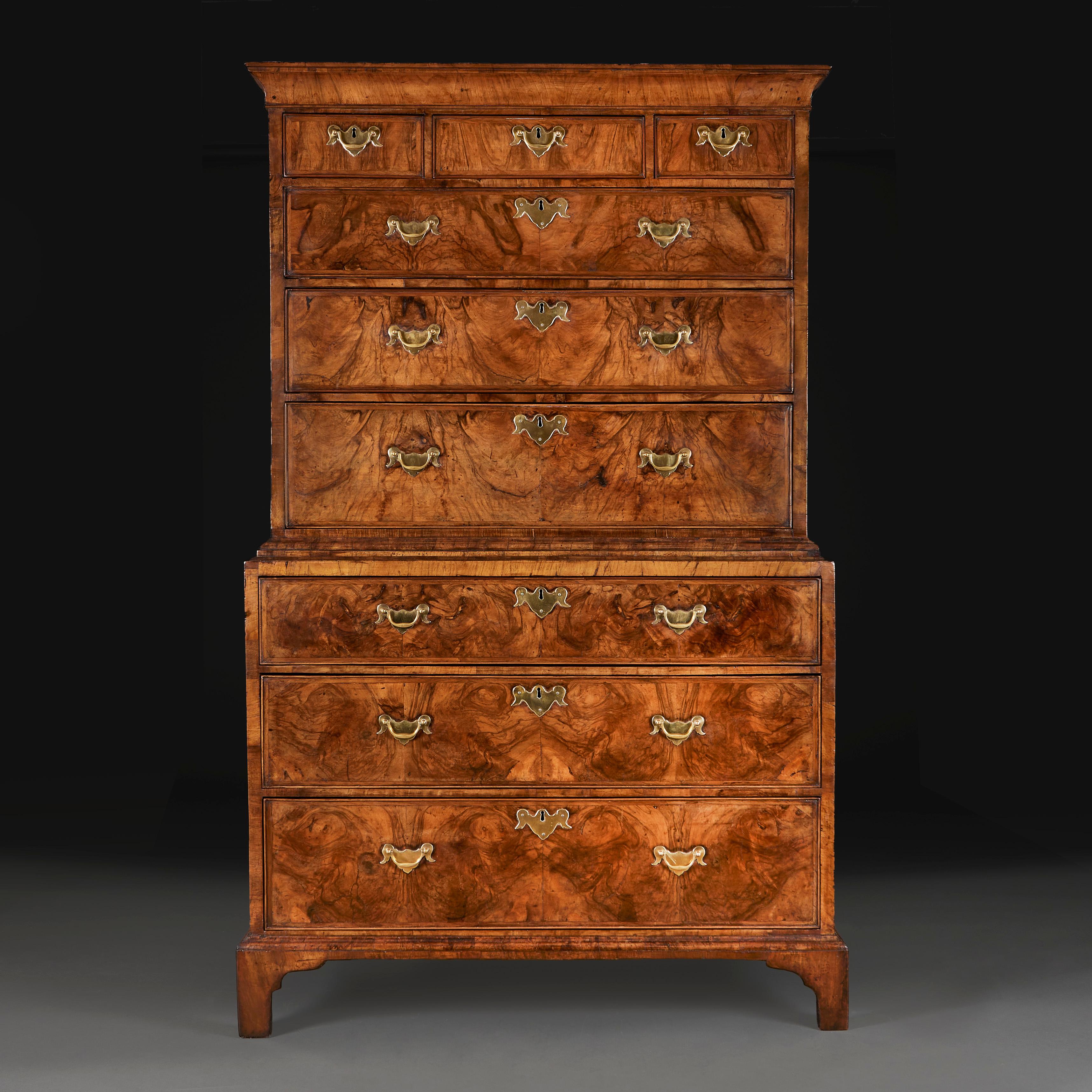 England, circa 1740.

A fine George II walnut chest on chest, with original brass escutcheons and handles, the top with concave moulded cornice above three short and three long graduated drawers, the base opening with three further long drawers, all