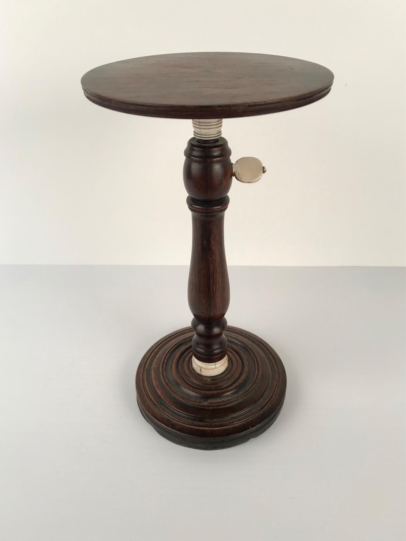 Made towards the end of the 18th century, its original purpose was to increase and decrease the amount of light, for reading, embroidery and suchlike, by raising and lowering the pedestal, which moved the candle up and down. This particular example