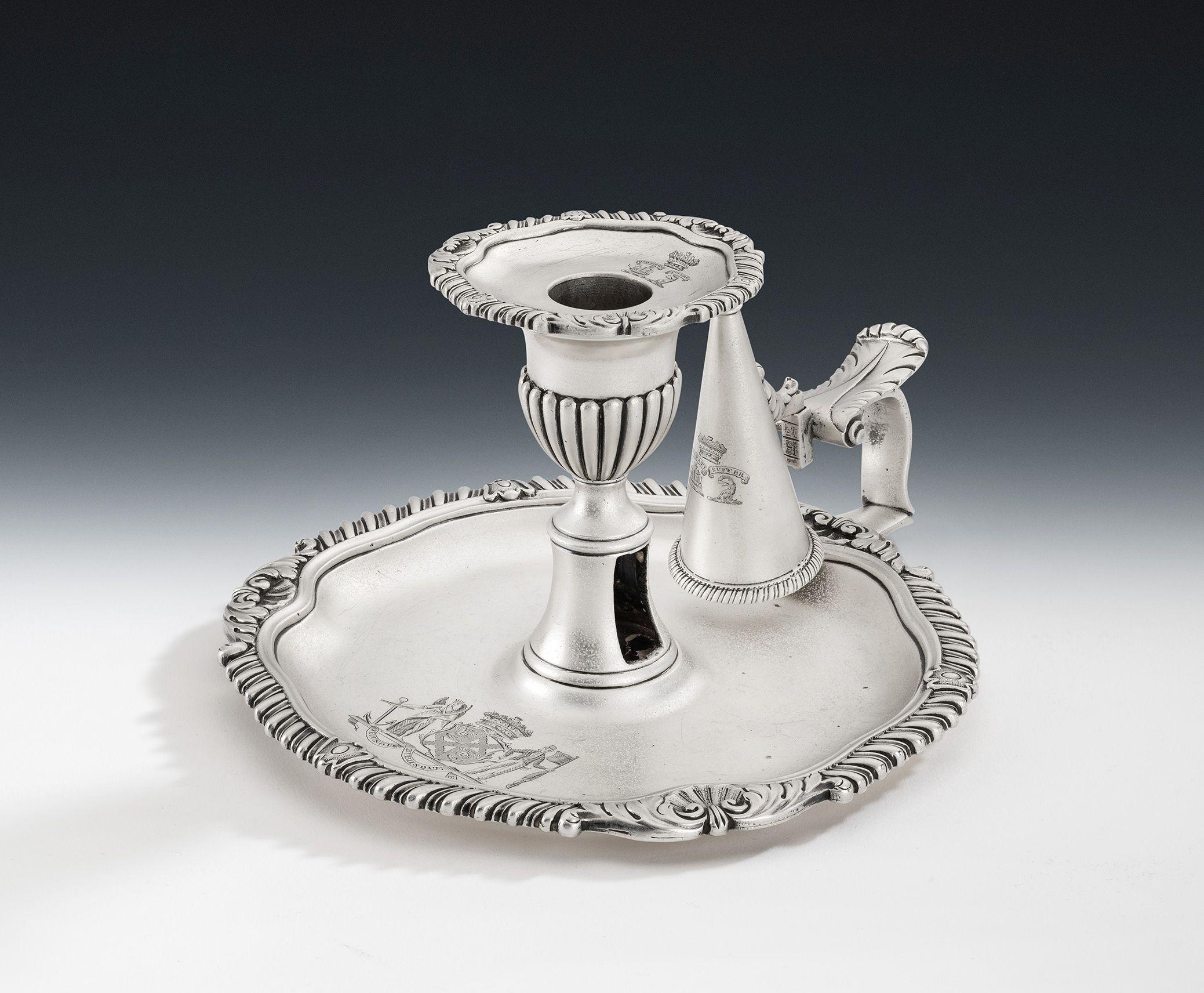 This exceptional chamber candlestick has a shaped circular base with raised rim decorated with gadrooning interspersed with anthemions as well as raying shells, flanked by acanthus leaves. The central shaft rises to a tulip shaped capital decorated