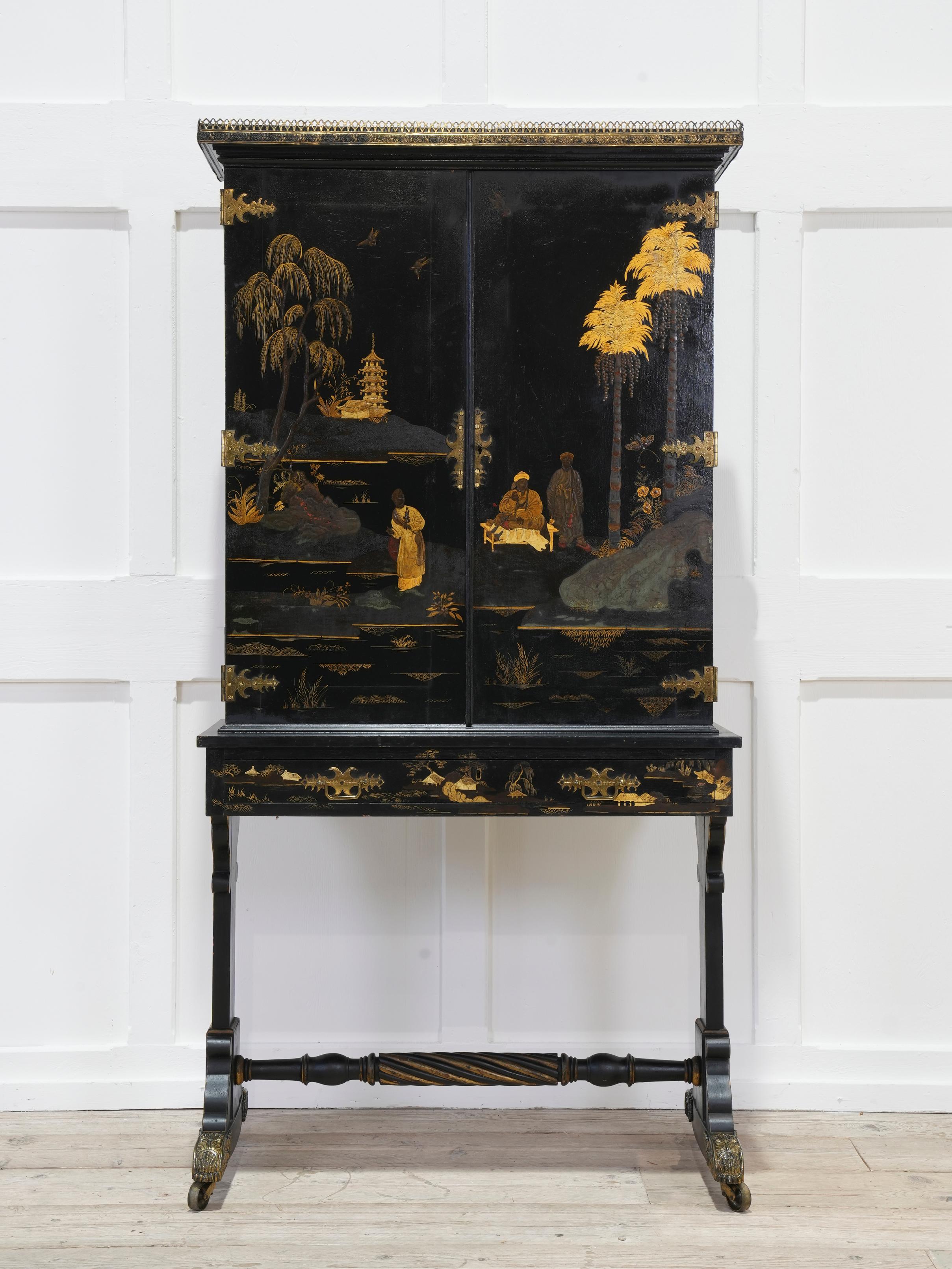The cornice with pierced brass decoration above cabinet doors mounted on ornate gilt brass strap hinges, the interior had twenty four pigeon holes above open storage and seven drawers all with there original brass furniture, the twin pedestal base