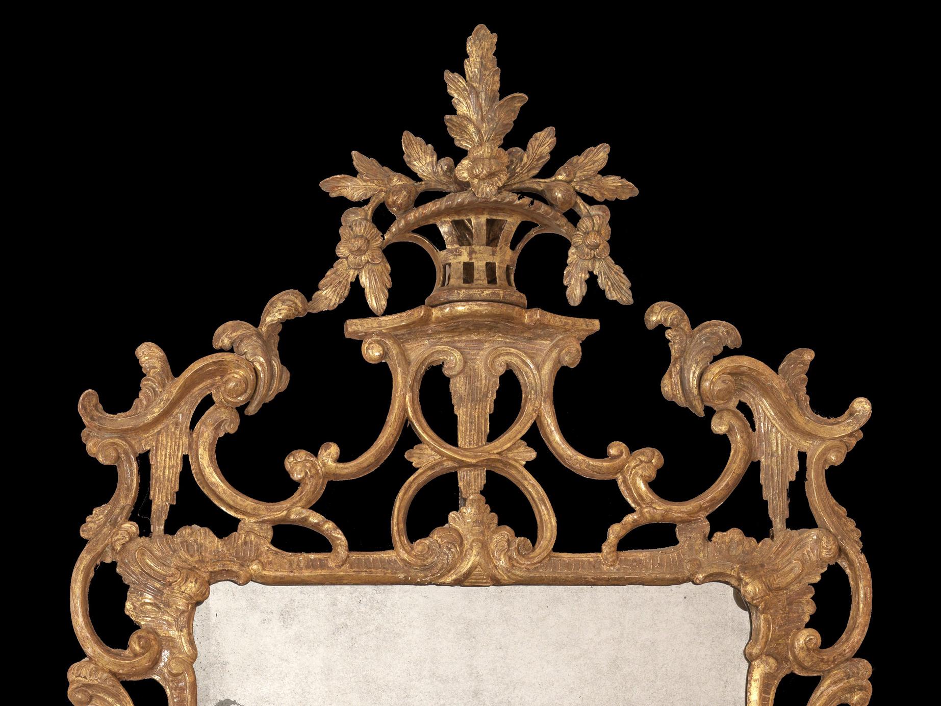 A fine quality mid-18th century Chippendale period carved giltwood mirror. The rectangular border glass mirror, retaining its original gilding and original plate, within a design of sweeping and delicate C–scrolls and acanthus leaf, pierced foliate