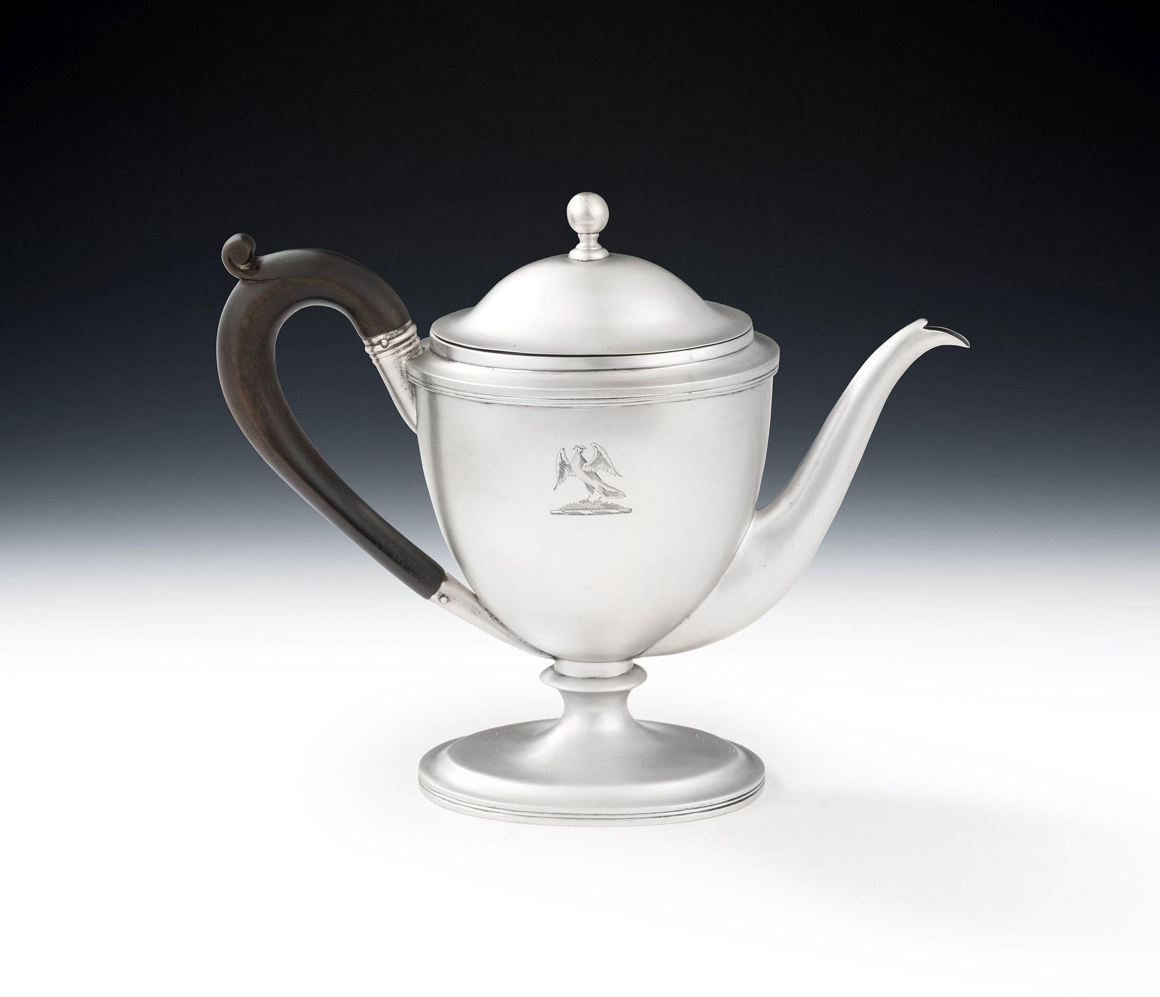 A RARE GEORGE III COMBINATION ARGYLE/BACHELOR TEAPOT MADE IN LONDON IN 1805 BY JOHN EMES.

This piece stands on an oval, stepped, pedestal foot decorated with reeding. The oval vase shaped body rises to a reeded rim and is engraved with a