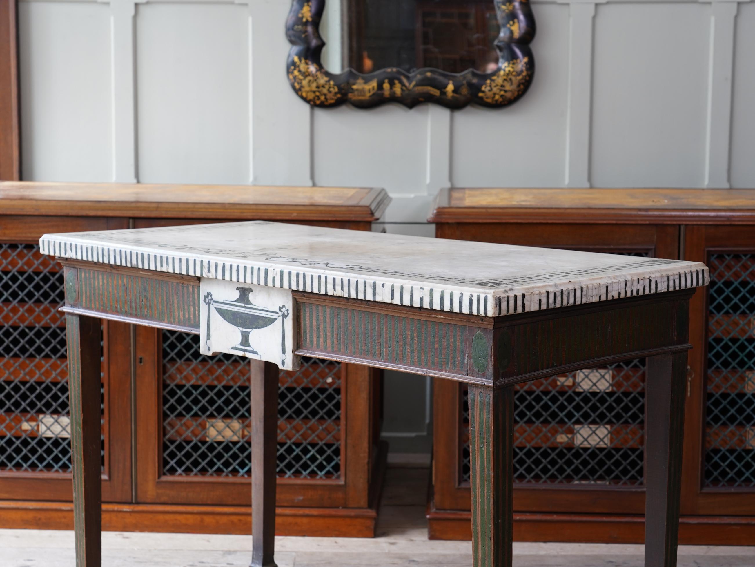 In the manner of Pietro Bossi, the scagliola inlaid marble top and frieze tablet, raised on square tapering legs with block feet, all with the original painted simulated fluting.
 