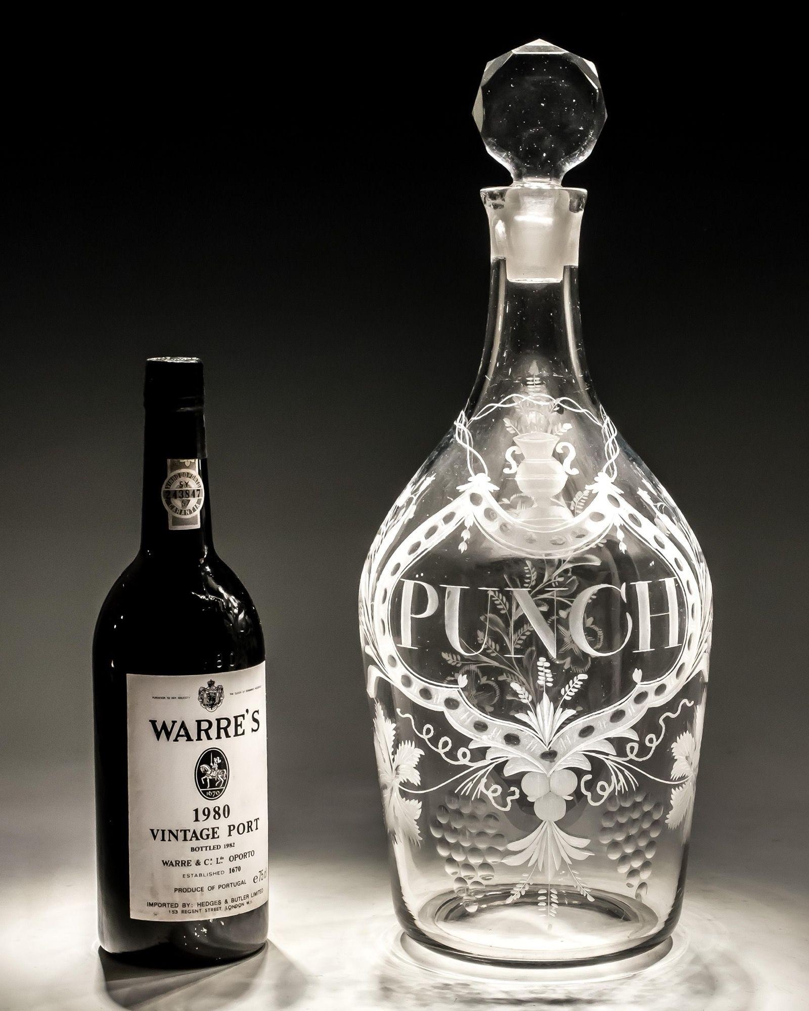 A rare Georgian Period decanter of exceptional size, the decanter of shoulder form finely engraved with a 'PUNCH' cartouche and fruiting vines, fitted with a facet cut stopper.