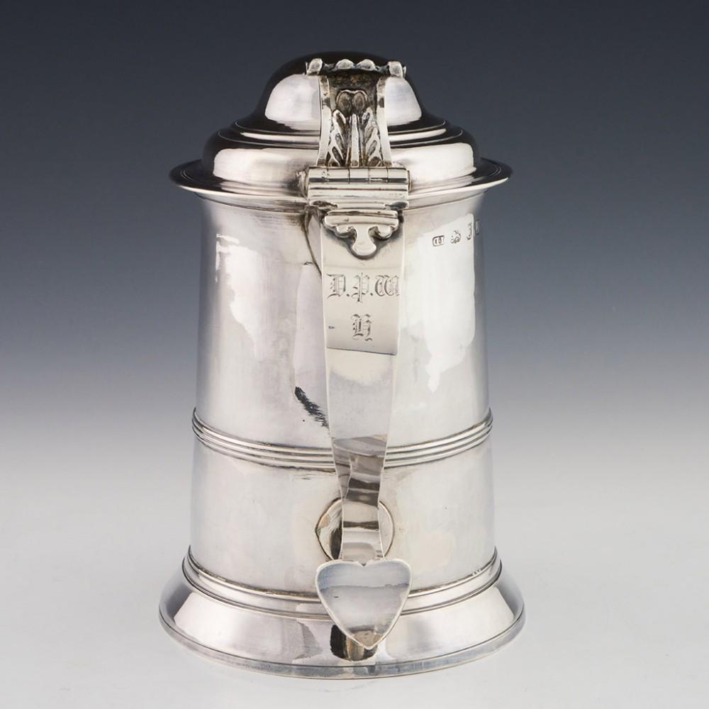 A George III Domed Lid Sterling Silver Tankard London, 1771

Additional information:
Date : Hallmarked in London 1771 For John Delmester
Period : George III
Origin : London England
Decoration : Scroll thumb-piece and reeded lid. S scroll handle.
