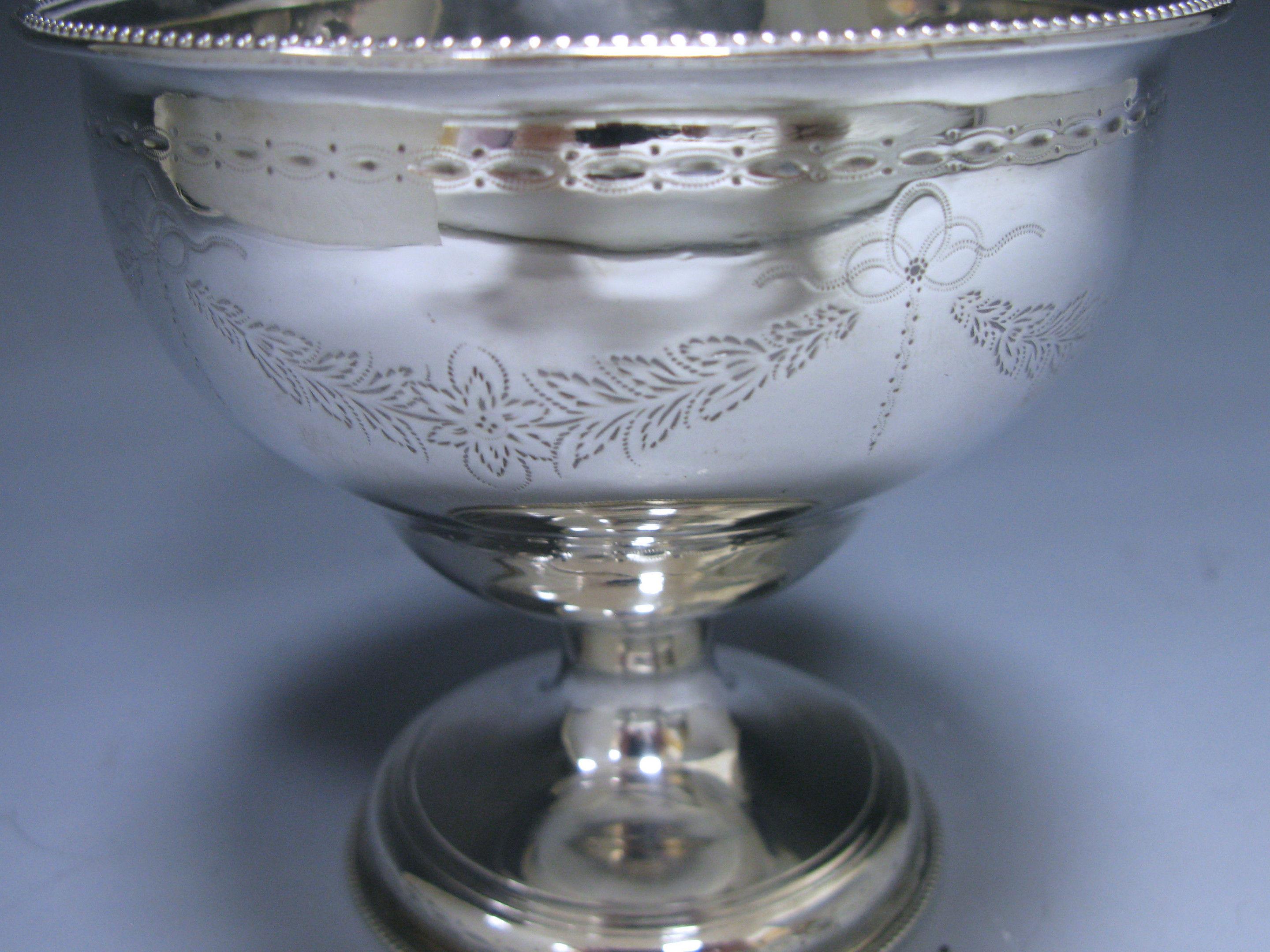 A charming George III Irish silver pedestal sugar bowl, with bright engraved decoration and beaded borders. There is a family crest engraved on the main body.

Measures: Diameter 5 inches 12.7 cm
Height 4.5 inches 11.4 cm.