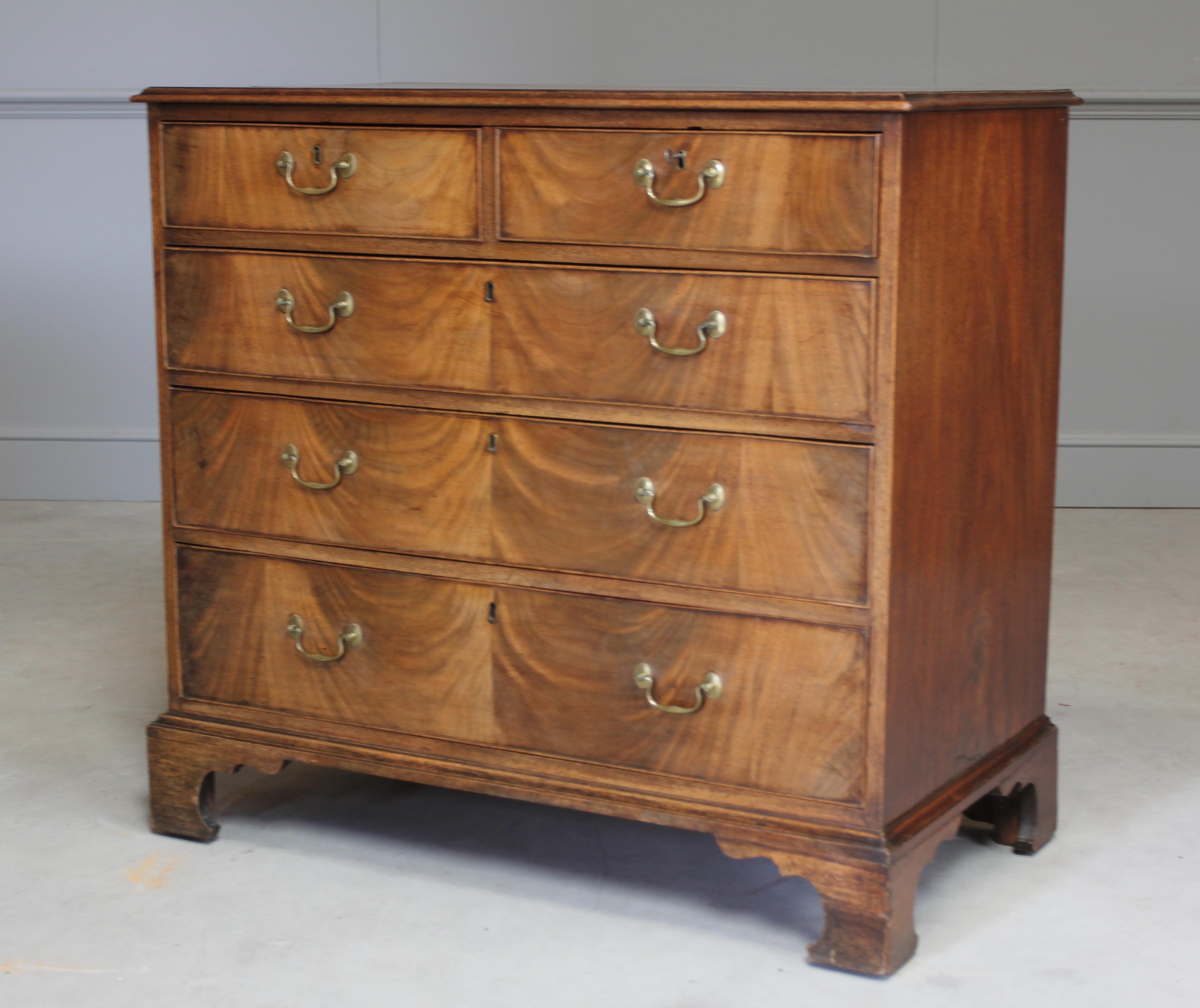 A George III mahogany chest of two short over three long graduated drawers with brass swing handles on bracket feet. With a working key for one safe drawer.

Coming from the period of King George III this chest of drawers is truly something
