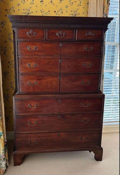 A George III mahogany chest on chest with applied blind fretworadpated as a bar.