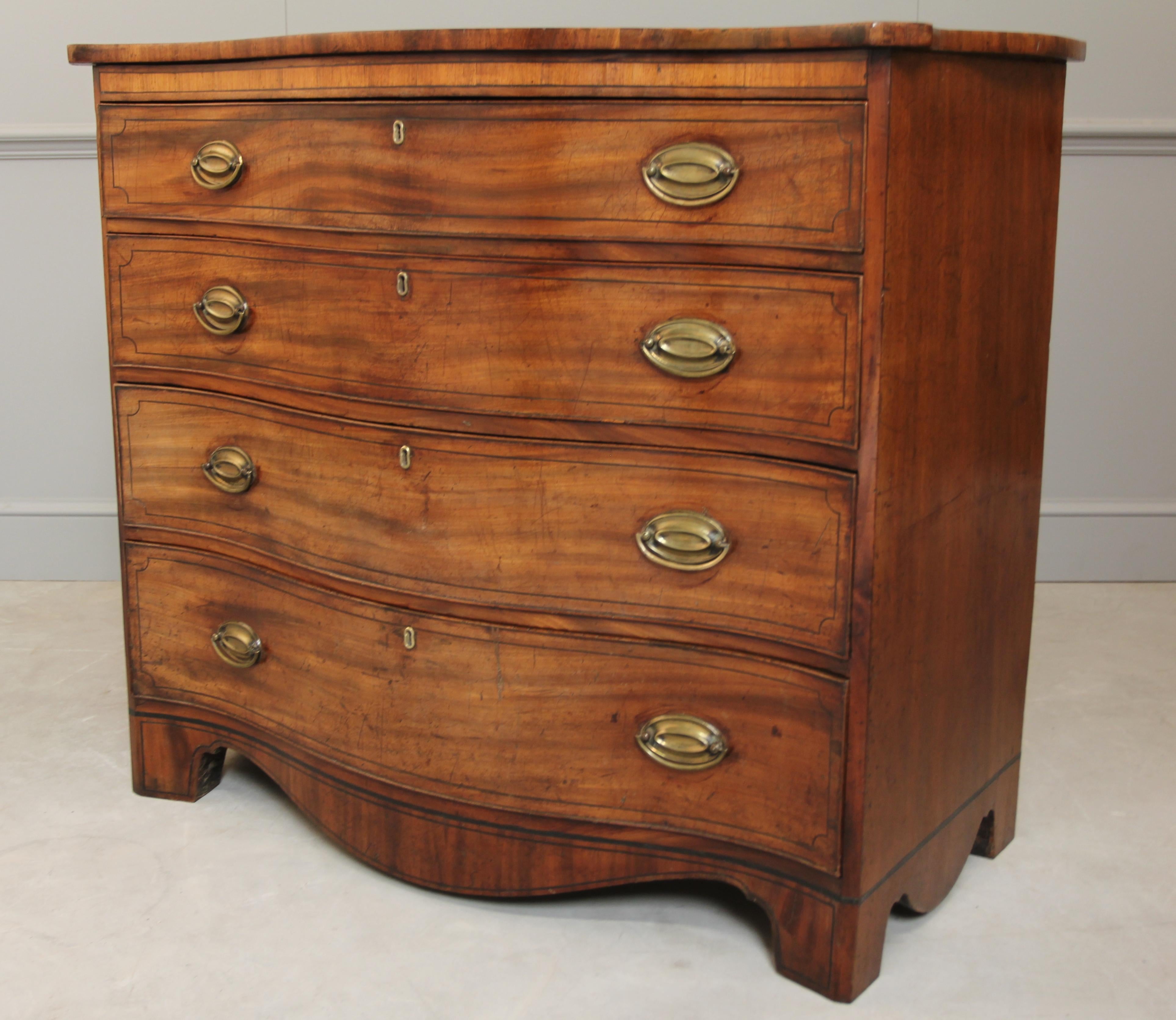 A George III mahogany serpentine chest of drawers with satinwood banding and ebony inlay stringing and four graduated long drawers, top drawer divided into three. all drawers run smoothly.
Measures: H 104cms x W 120cms x D 59cms
Coming from the