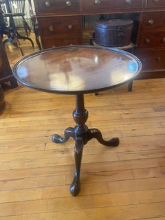 A George III mahogany side table with well patinated, dished, circular top.