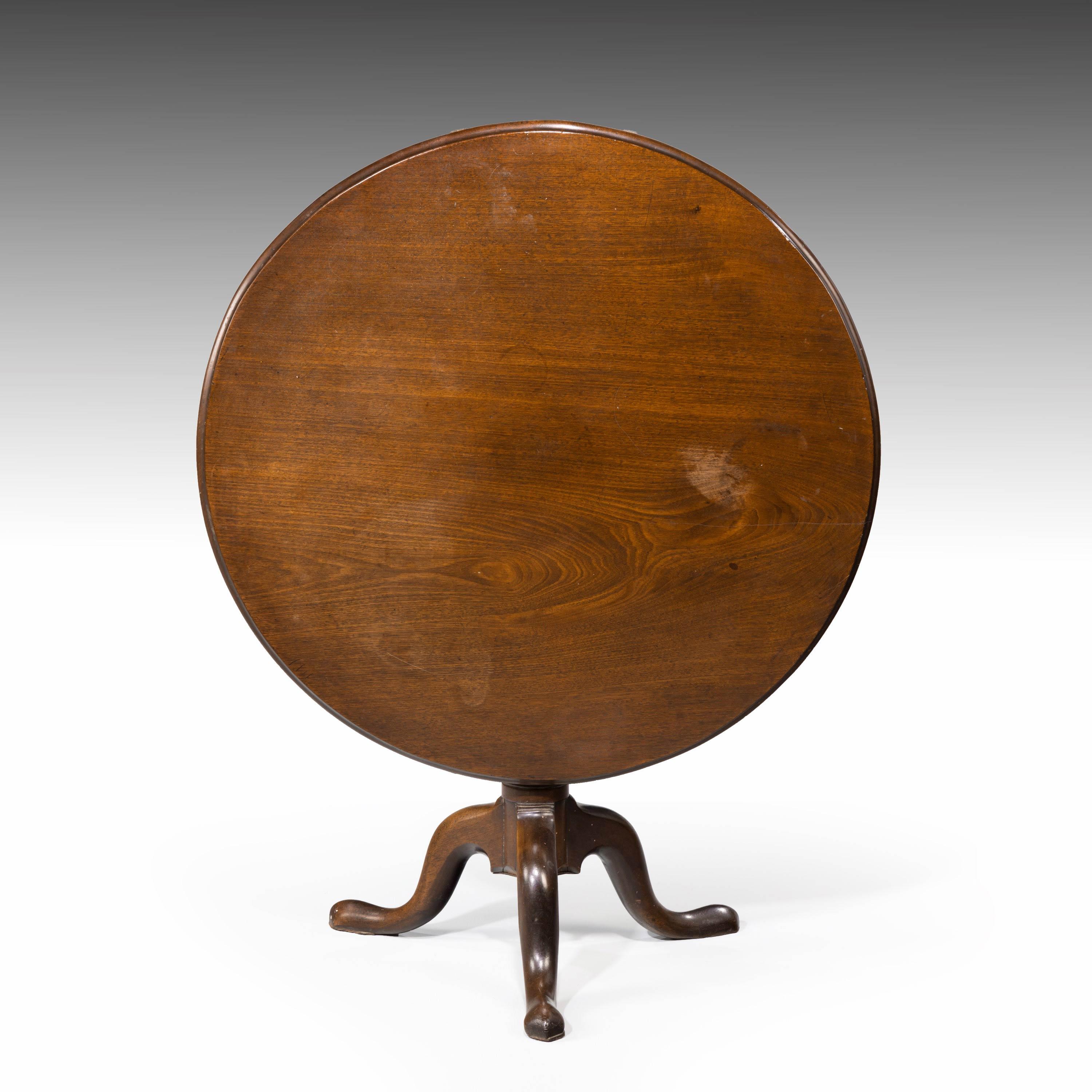 A George III period mahogany tilt table of substantial size. The one piece top beautifully figured and well patinated. On a spiralled turned pod over three cabriole supports.