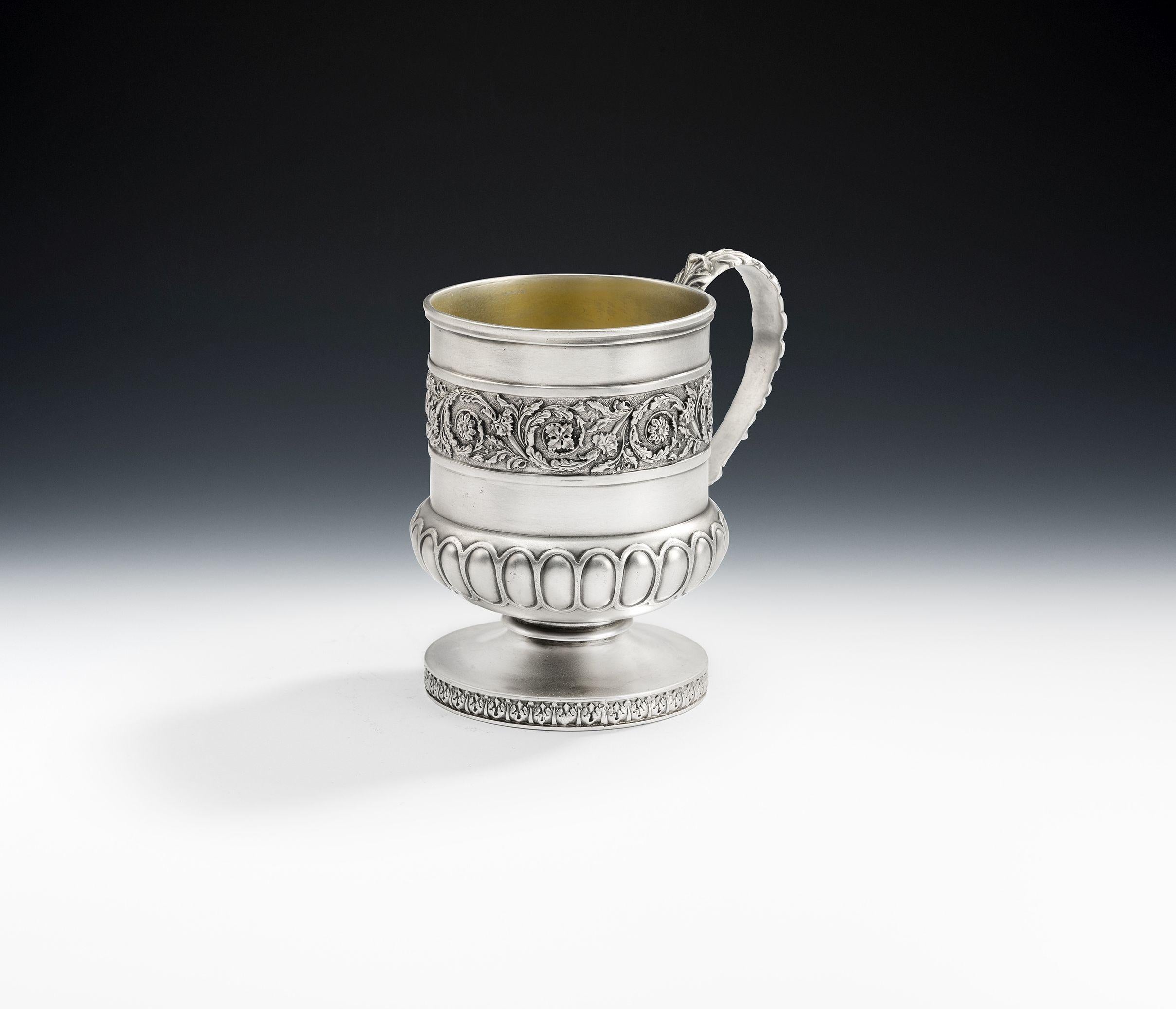 This very unusual mug is of a smaller size and was almost certainly for the use of a Lady or child. This fine piece stands on a circular pedestal foot which is decorated with foliate spears. The main body is of campana form with a lower baluster