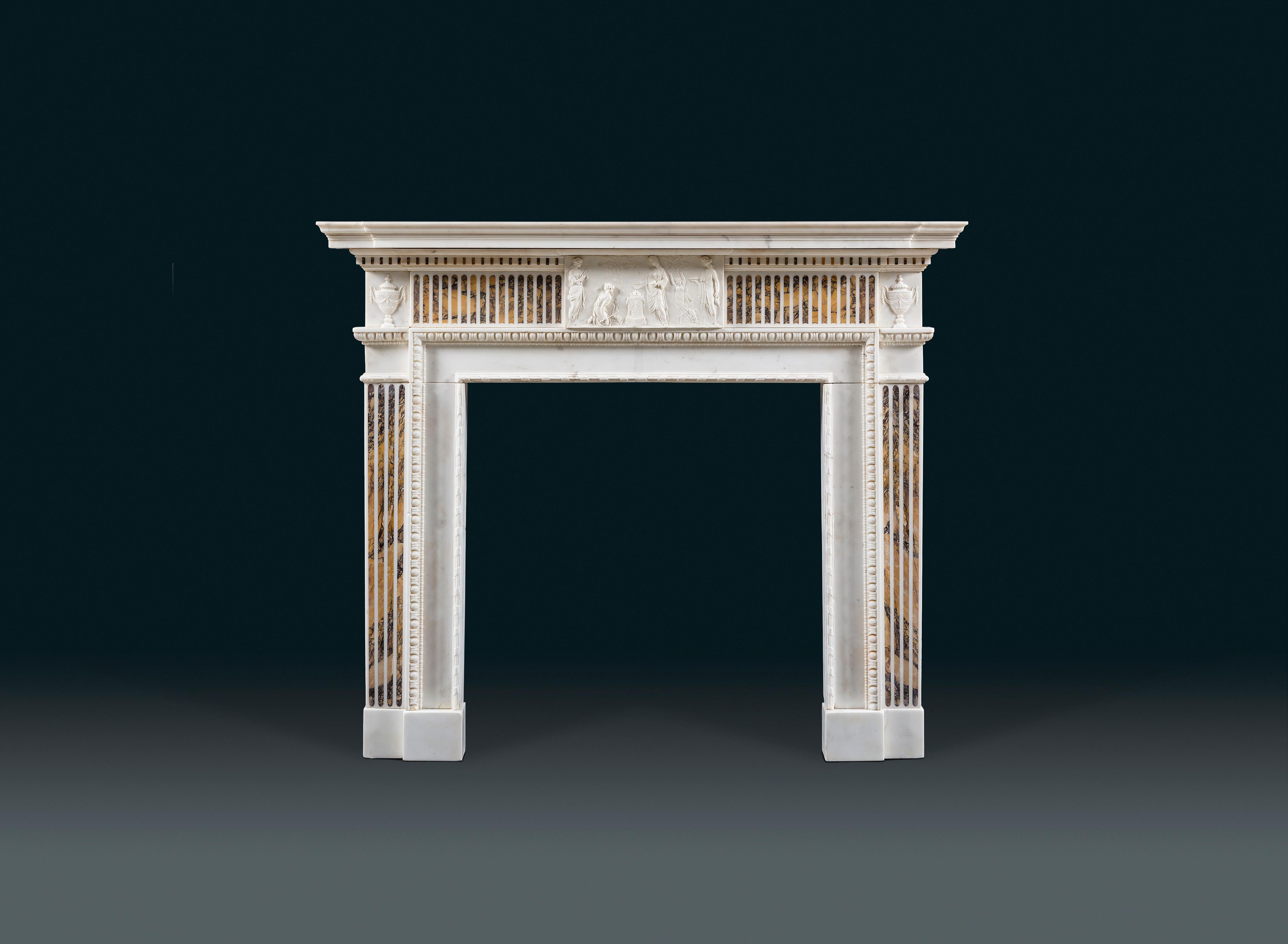 A very fine George III neoclassical chimneypiece in statuary and Siena marbles. The central tablet is carved in low relief depicting a Vestal Virgin conducting a harvest sacrifice. She is flanked by dancing muses bearing flutes and lyres and