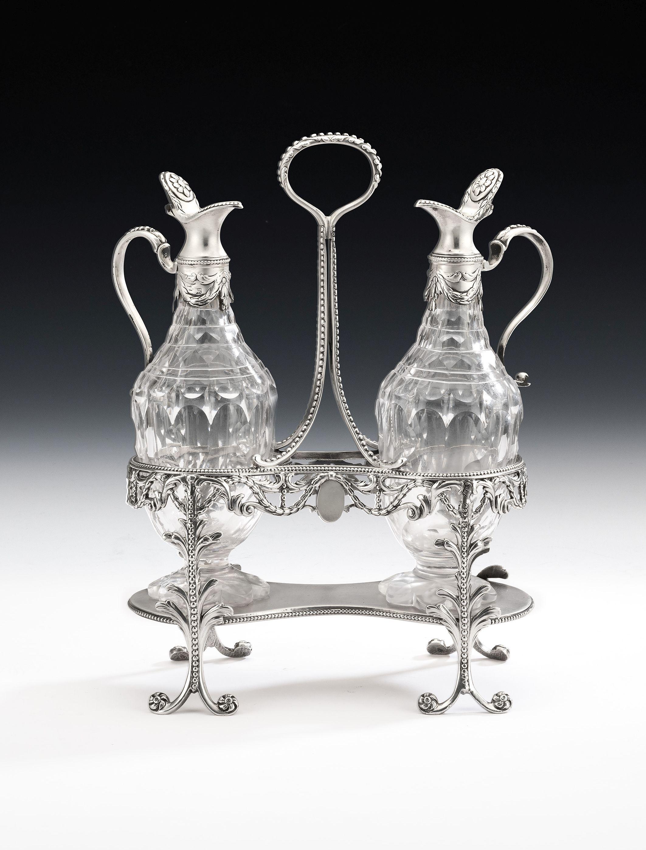 This rare and important George III neoclassical oil and vinegar Cruet made in London in 1777 by Thomas Daniel. The Cruet is modelled in the high neoclassical tradition and displays four beaded legs with bi-furcated ends and scroll feet, decorated