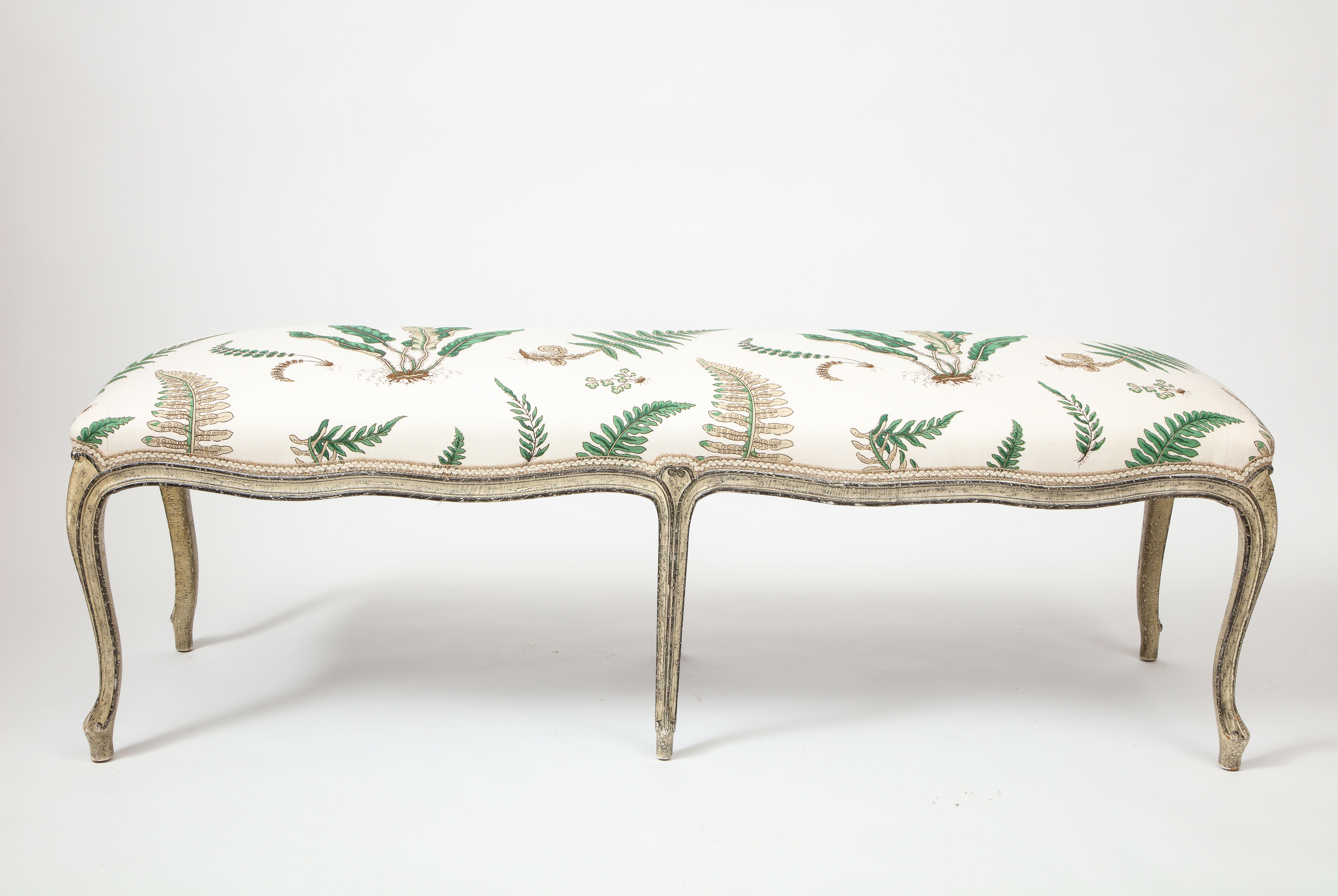 Of generous scale and with both front and back of serpentine form so bench can float nicely in a room if needed; the seat newly upholstered in Baker's Ferns over a channeled seat rail and cabriole legs ending in pad form feet. The wood frame painted