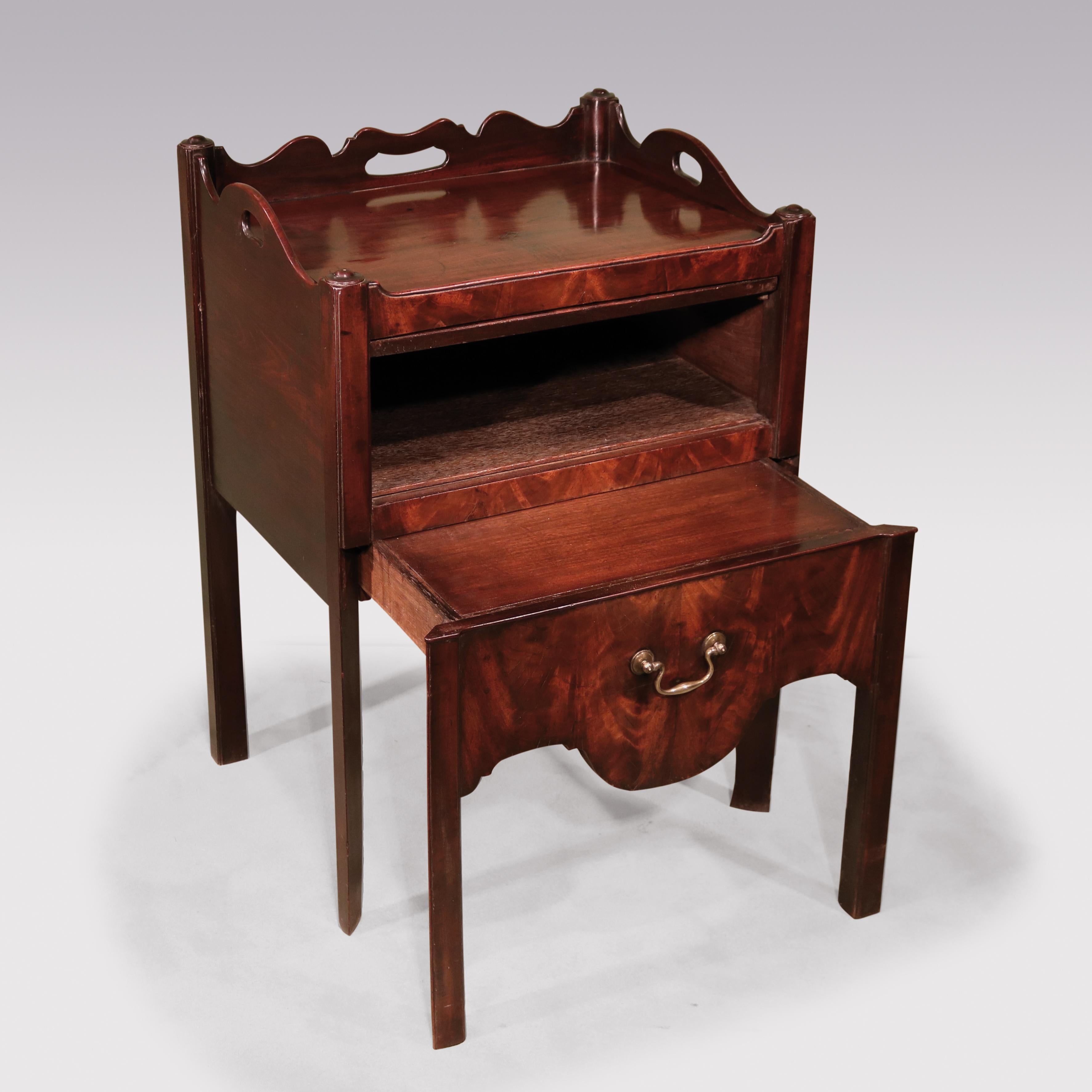 A late 18th century George III period well-figured mahogany tray top commode, having pierced handled gallery above flame figured “up and over” door and converted commode drawer, retaining original brass swan neck handle supported on square legs.