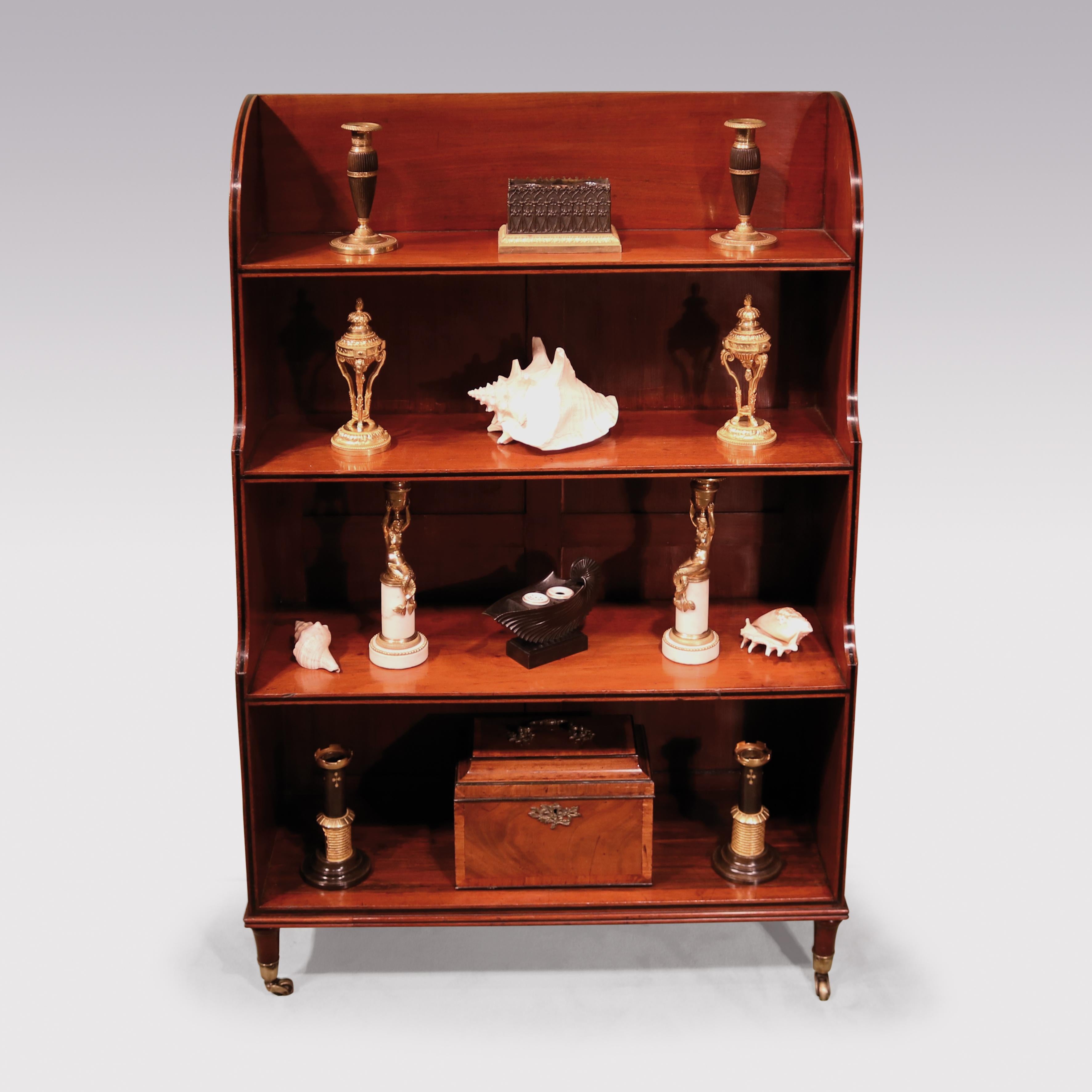 A George lll period figured mahogany Waterfall bookcase, having ebony banding to the shelves with shaped sides, supported on short turns legs ending on original castors.