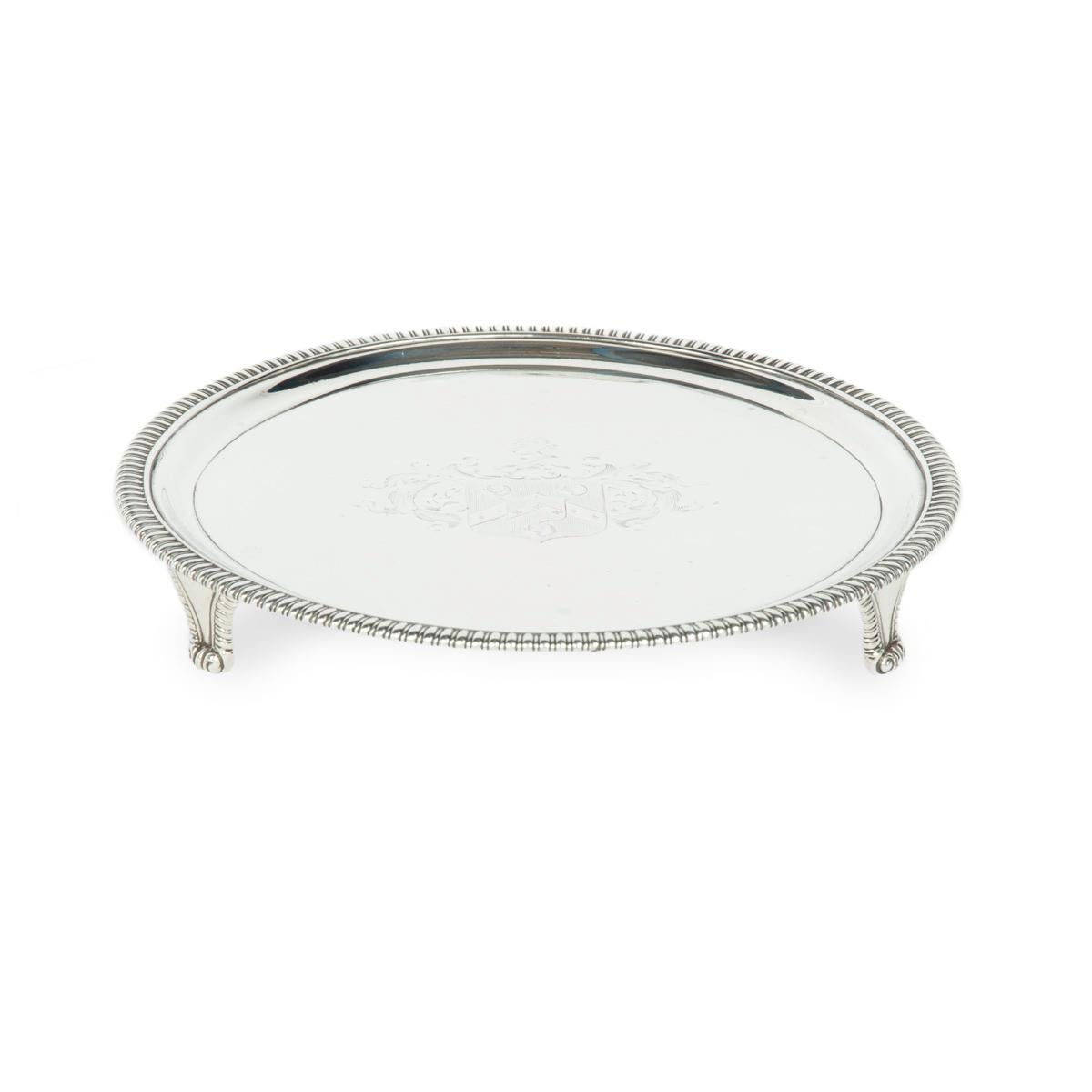 A George III silver tray commemorating the marriage of Admiral Thomas Le Marchant Gosselin, of circular form raised on three bracket feet, incised with the armorial is for the family of Gosselin with Hadsley in pretence, hallmarked to the underside