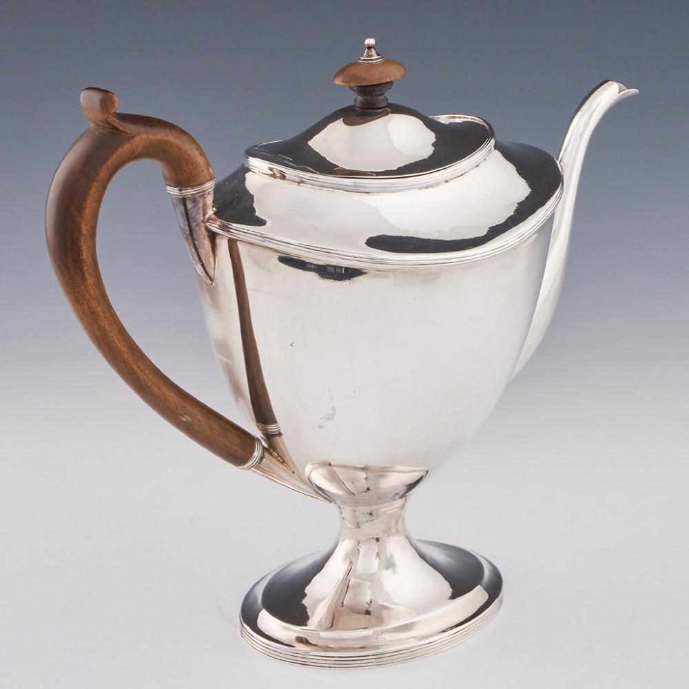 A George III Sterling Silver Coffee Pot London, 1805

Additional information:
Date : Hallmarked in London 1805 For Samuel and George Whitford
Period : George III
Origin : London England
Decoration : Reeded decoration. Pedestal foot and scroll wooden