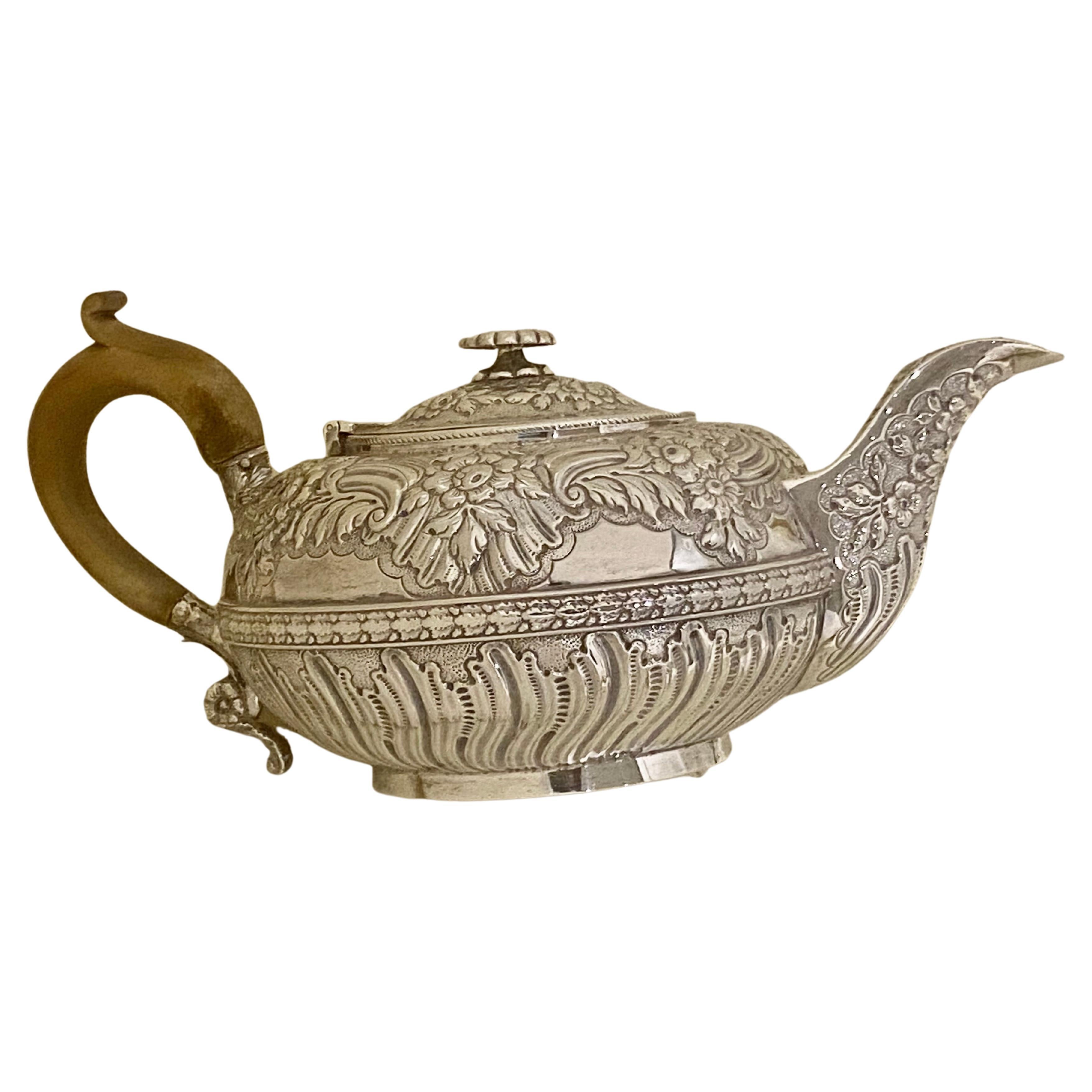 A stunningly beautiful large circular English Sterling silver teapot, beautifully floral embossed throughout 
This is a superb example of a antique George III solid sterling silver teapot,  weighing 630 grams. 20.25 troy Onces and measuring 10.5