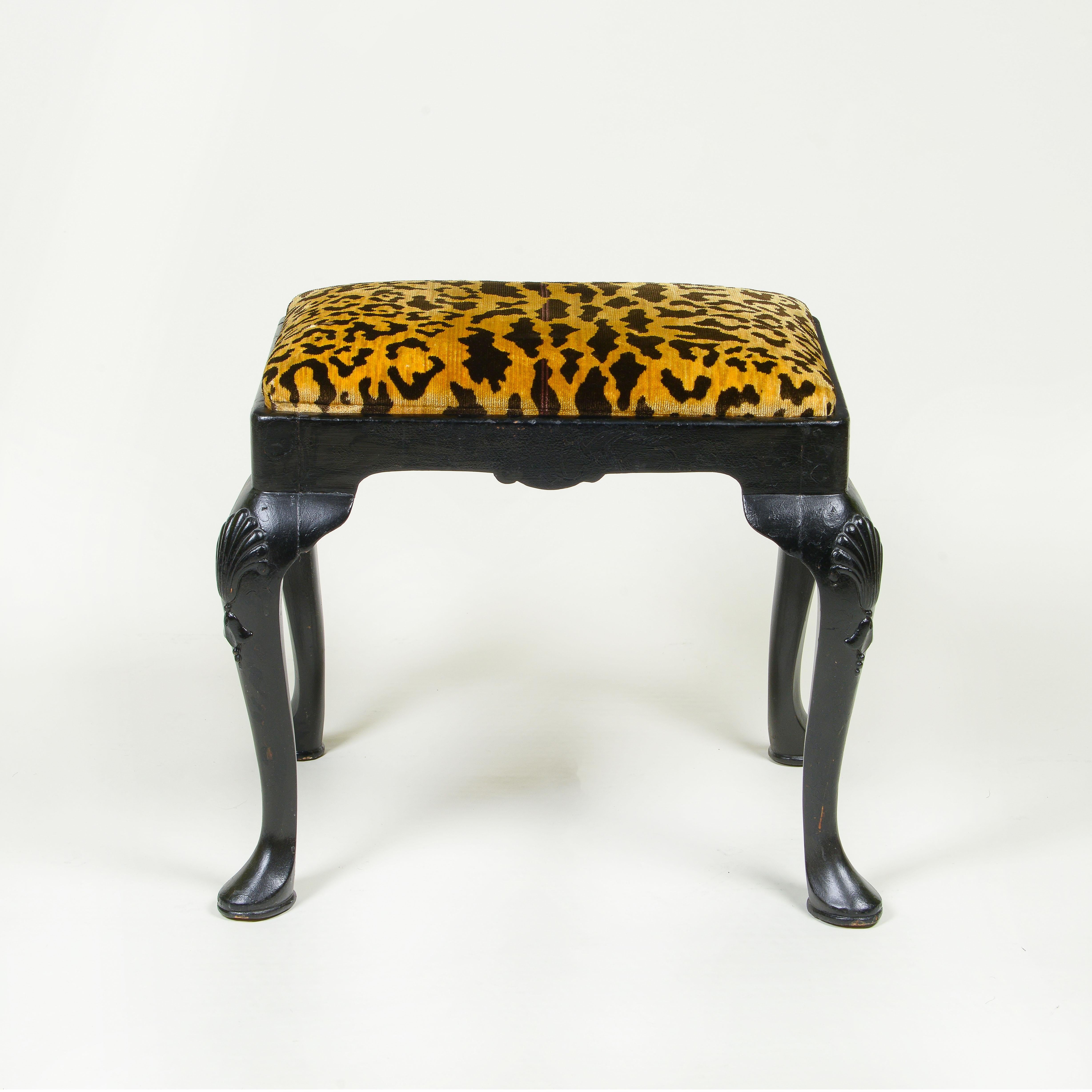 Raised on shell-carved cabriole legs; reupholstered with Clarence House leopard silk velvet.
