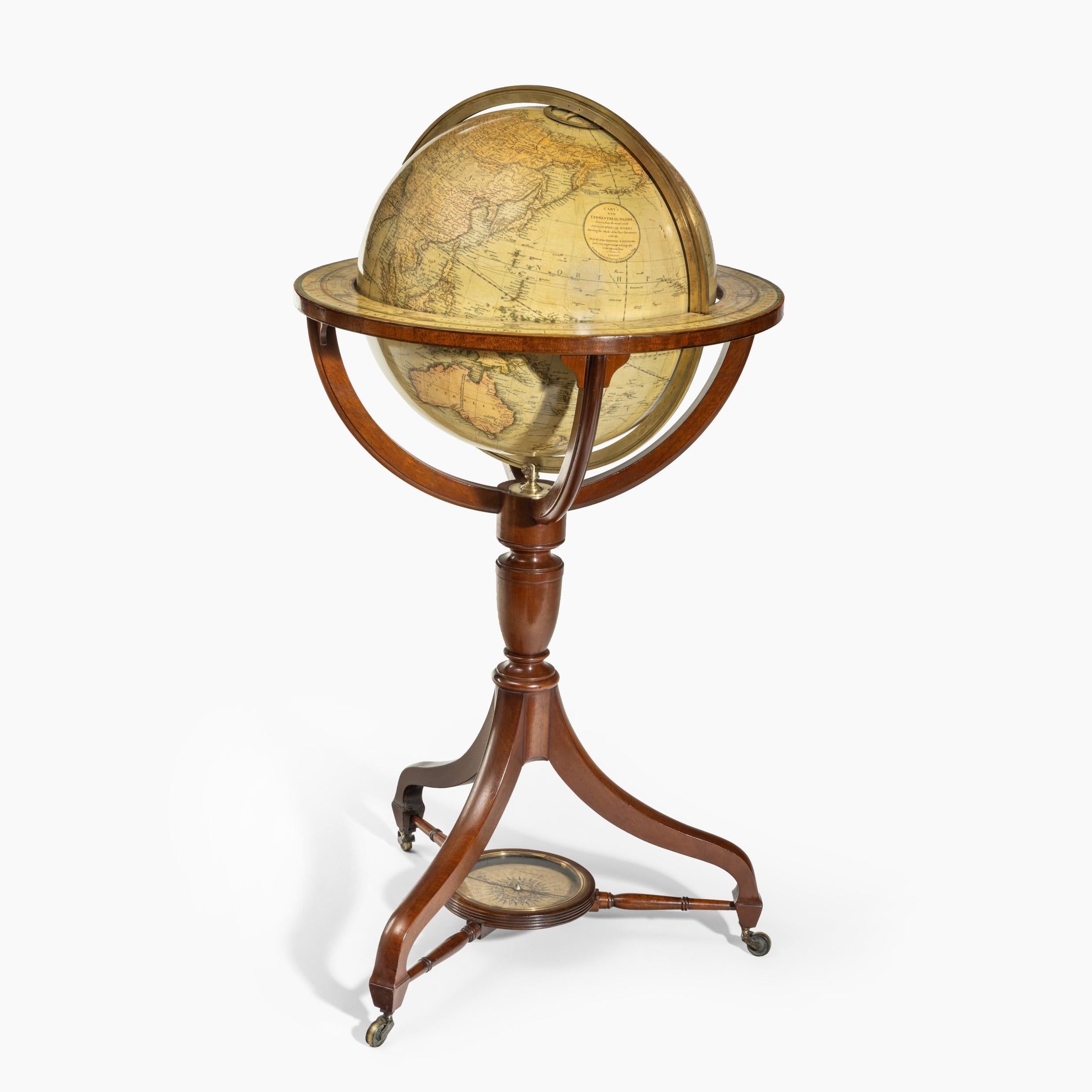 A George IV 18-inch floor-standing library globe by John Smith, set in a mahogany stand with a turned baluster support and three arched legs on brass castors joined by stretchers centred on a compass rose, the cartouche, surmounted by a royal crest,