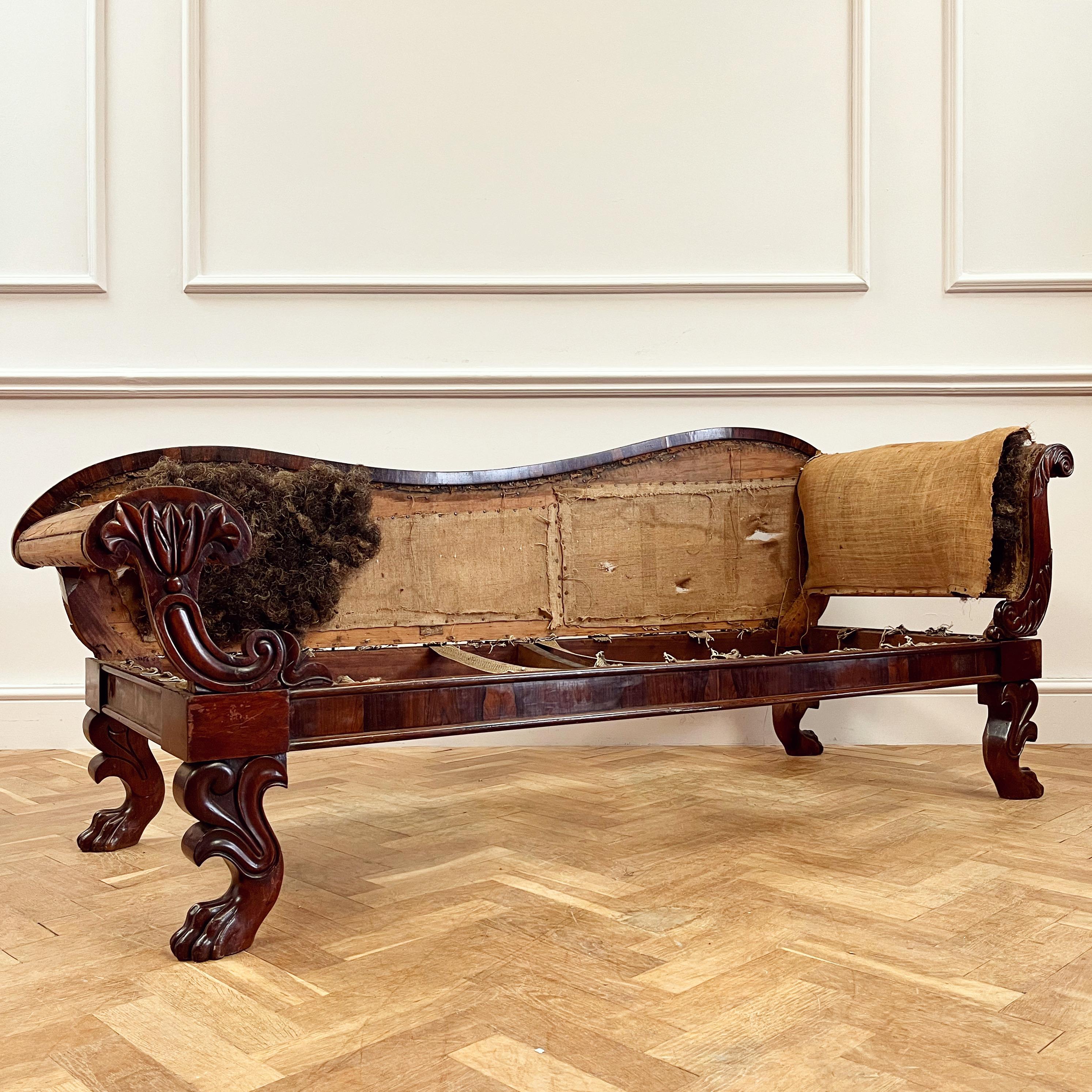 An Indian late George IV mahogany sofa, with shaped back and arms of scrolling acanthus leaves and standing on four lively lion paw feet. 

Price includes upholstery ex fabric.