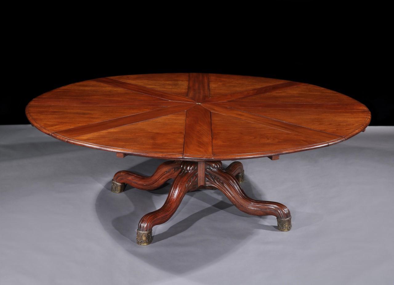 A very large and extremely rare William 1V mahogany extending Jupes table
By Johnstone and Jeanes. The round extendable top with two original sets of leaves, retaining the original leaf holder, resting on a central pillar with four shoot of moulded