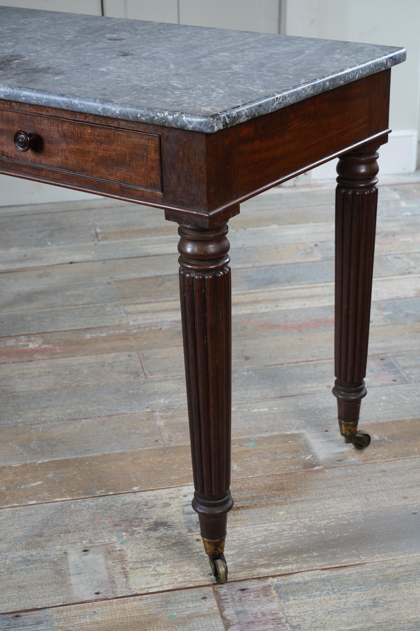 A George IV Mahogany Writing Desk with a Fossil Marble Top 10