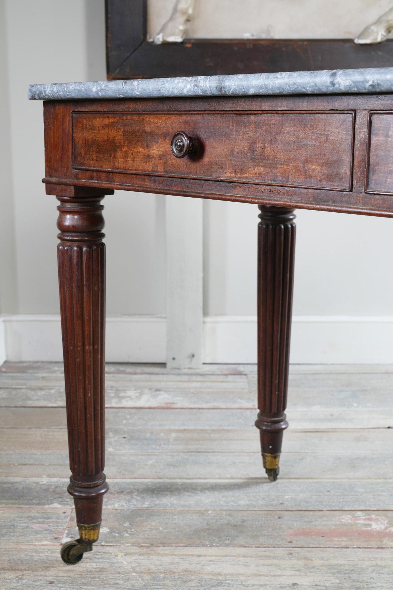 A George IV Mahogany Writing Desk with a Fossil Marble Top 2