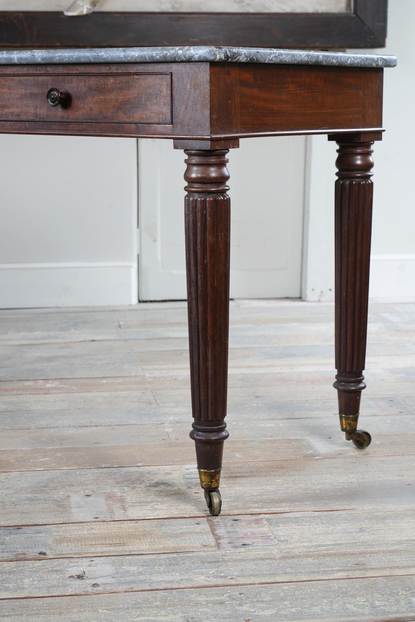 A George IV Mahogany Writing Desk with a Fossil Marble Top 3