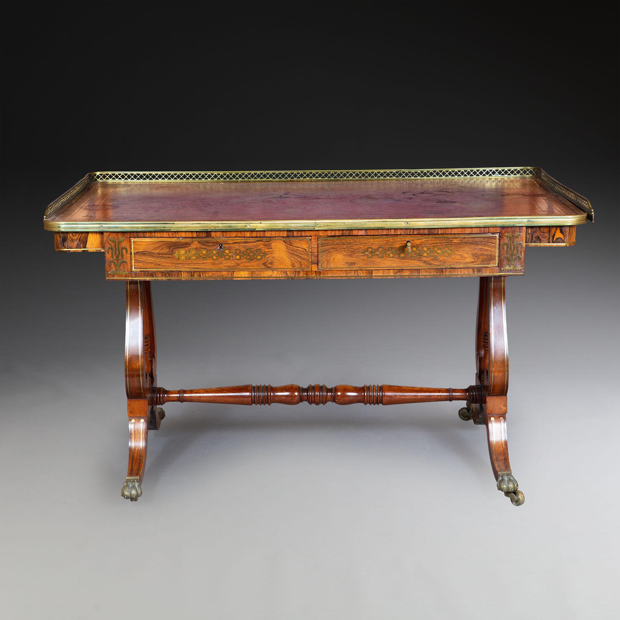 A George IV rosewood writing table. The rectangular tooled leather top, with a rosewood cross banded edge, and a pierced brass gallery, above two frieze drawer, resting on layer ends,
with brass toed casters.