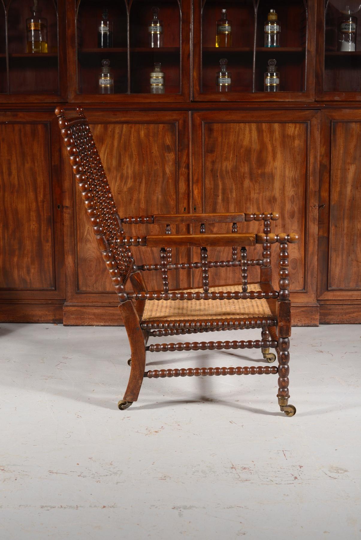 A fine George IV period simulated rosewood bobbin turned armchair, with cane seat, on its original substantial brass castors. 

This bobbin chair has a lovely rich colour and all over turned decoration with some lovely detail features which sets