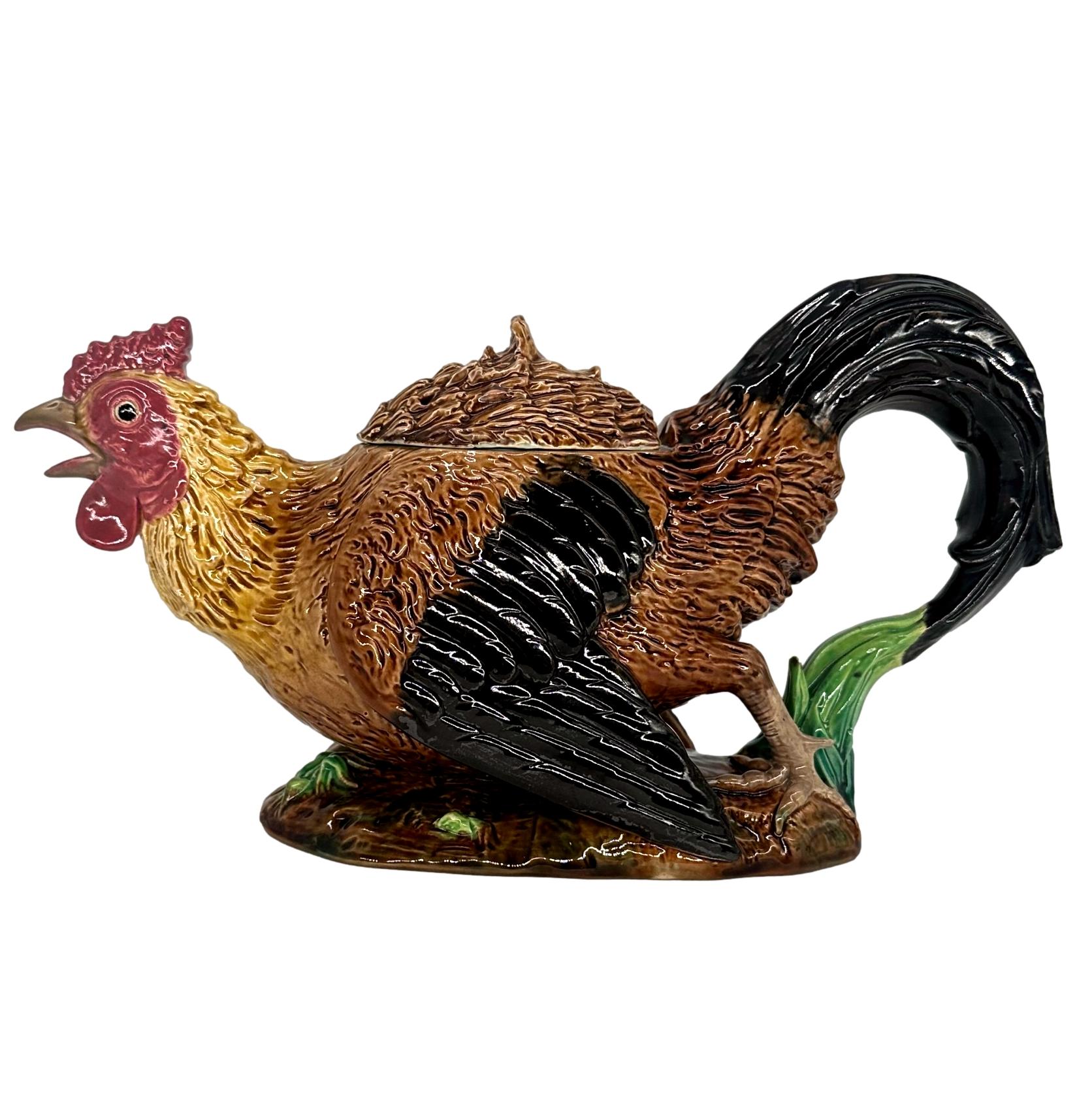 Una teiera in maiolica George Jones Rooster (Cockerel), inglese, 1872 circa, modellata in modo naturalistico come un gallo in corsa, le piume della coda formano il manico, il becco aperto il beccuccio. Riccamente smaltata in marrone, nero, verde,