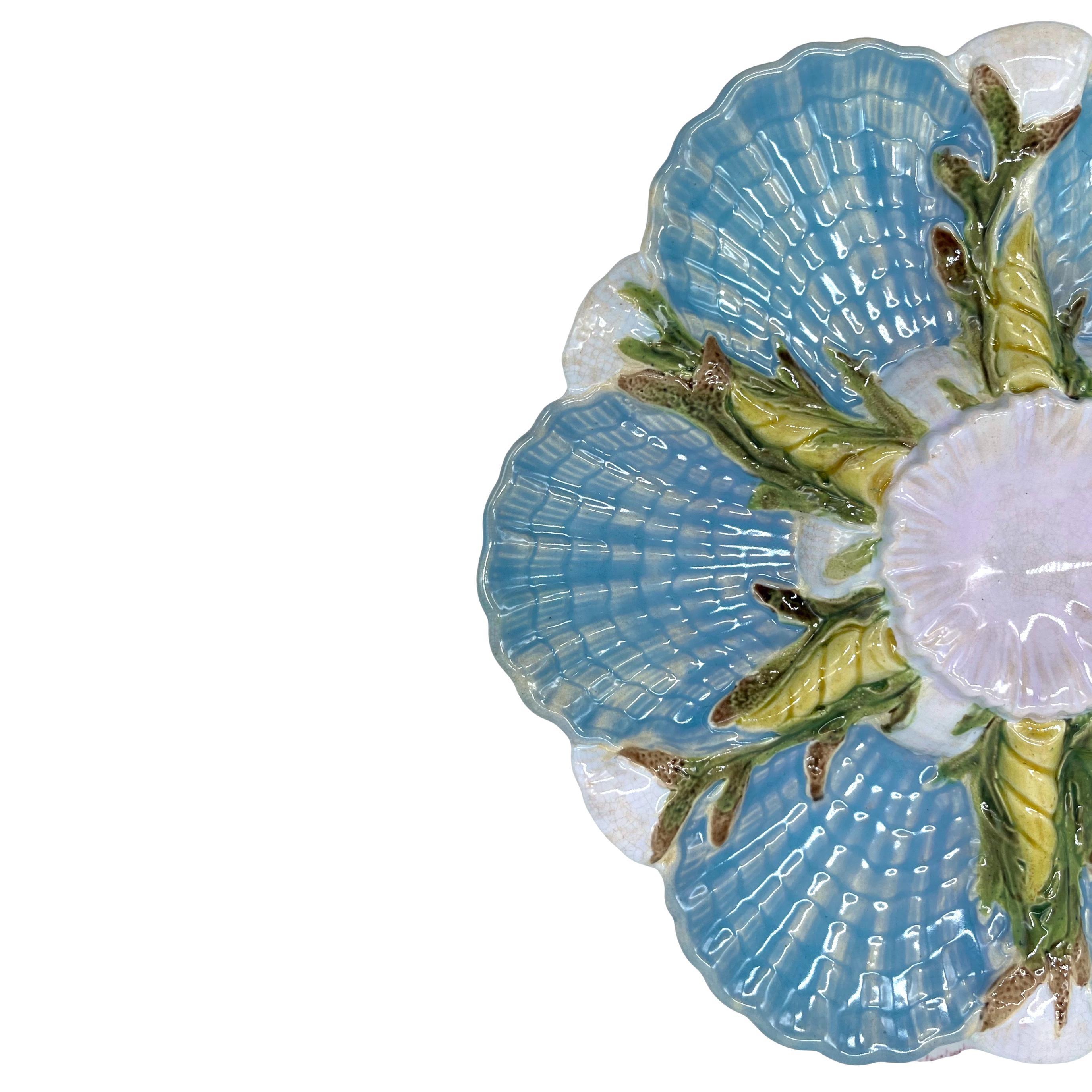 A George Jones Majolica Oyster Dish, the central well molded in high relief on a round mound of naturalistically molded and white-glazed scallop shells, with six open scallop shells with fluted and scalloped wells glazed in turquoise, separated by