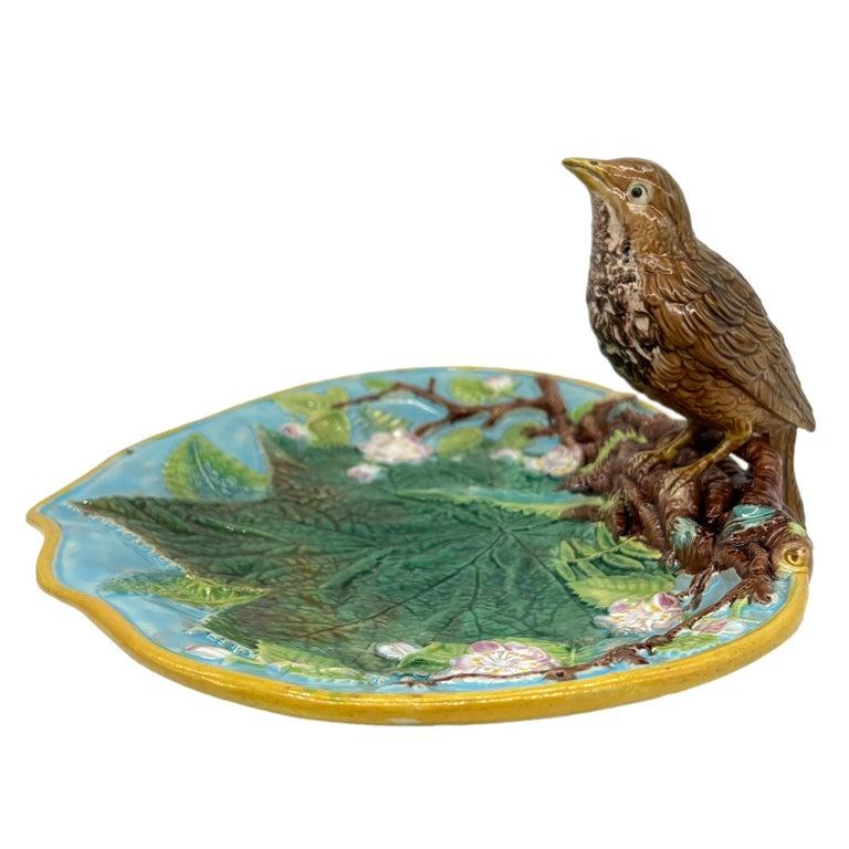 A George Jones Majolica Tray, the shaped dish with relief-molded leaves and ferns, with branches laden with orange blossoms, surmounted with a single naturalistically molded and glazed thrush, the reverse glazed in green and brown tortoiseshell