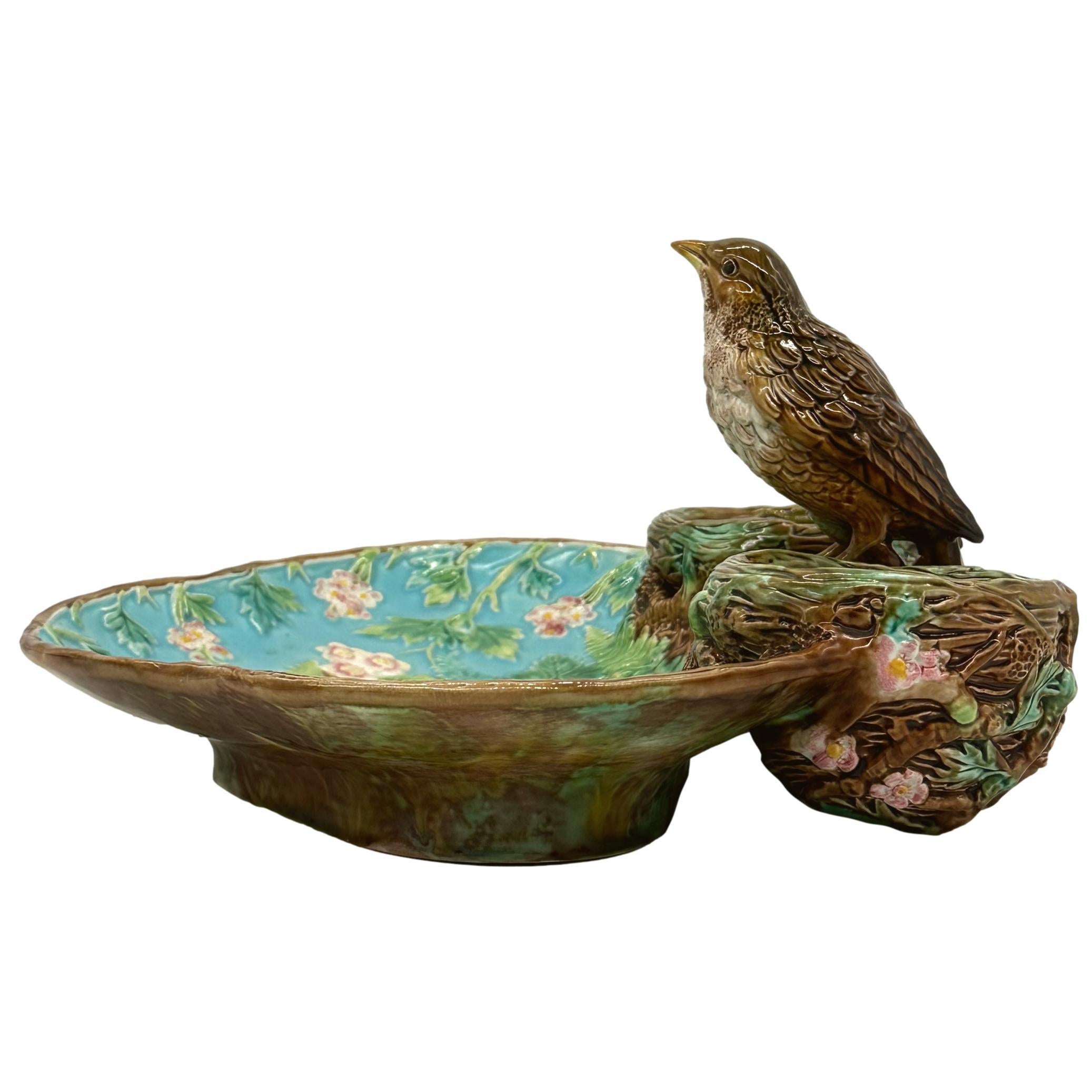 George Jones Majolica Strawberry Server, ca. 1870, the trefoil dish naturalistically moldelled with blossoming strawberry plants and ferns on a turquoise and rustic ground, surmounted by a life-Size Thrush perched on simulated branches between two