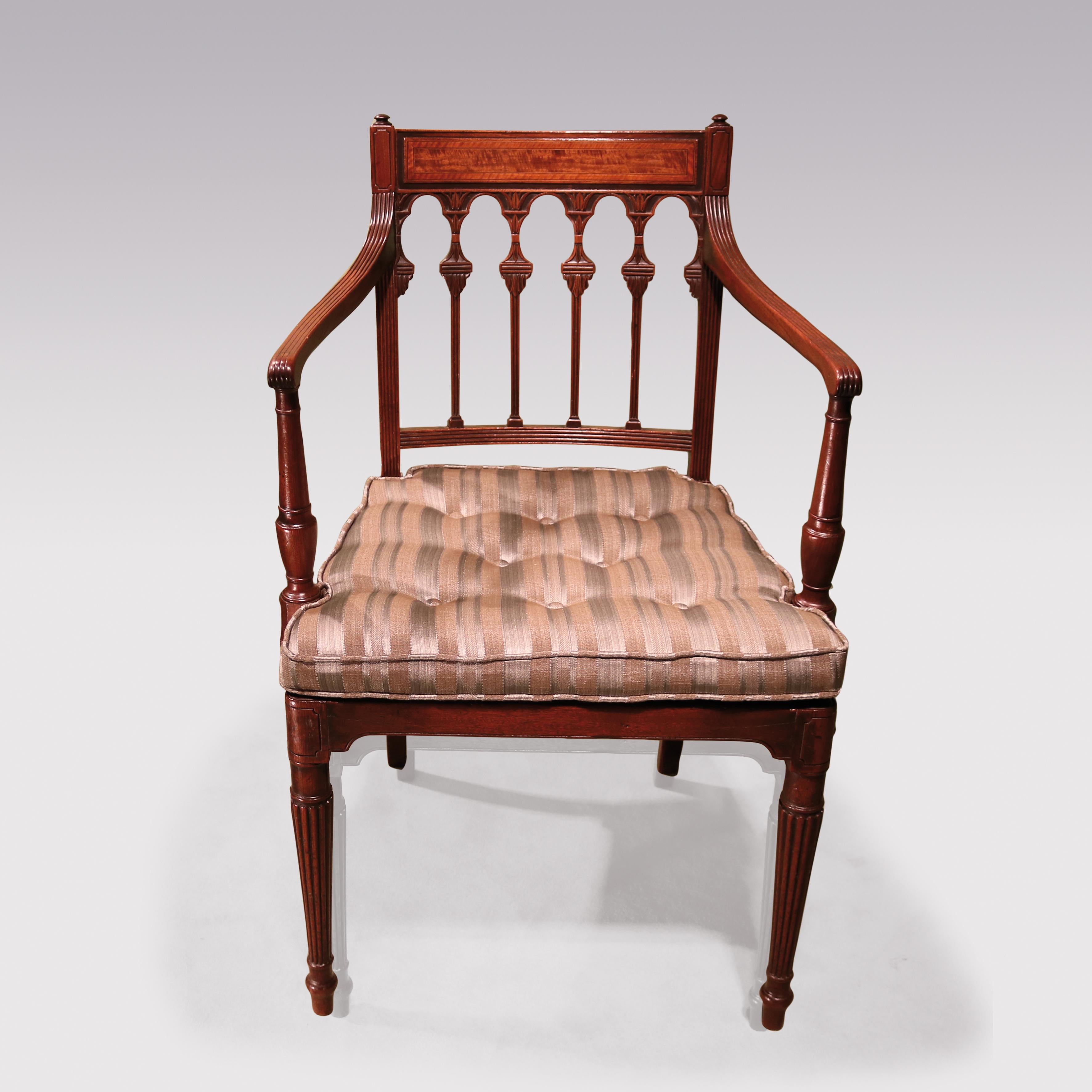 An attractive George III period mahogany Armchair, having boxwood & ebony satinwood panelled back above arched leaf-carved splats. The Chair with vase turned arm supports having caned seat and squab cushion raised on reeded tapering legs.