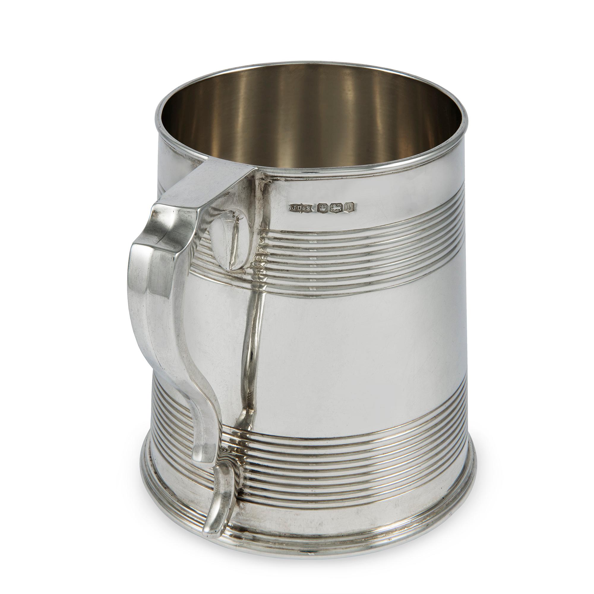 A George V sterling silver pint tankard, the straight sided body with reeded decoration, height 4.25