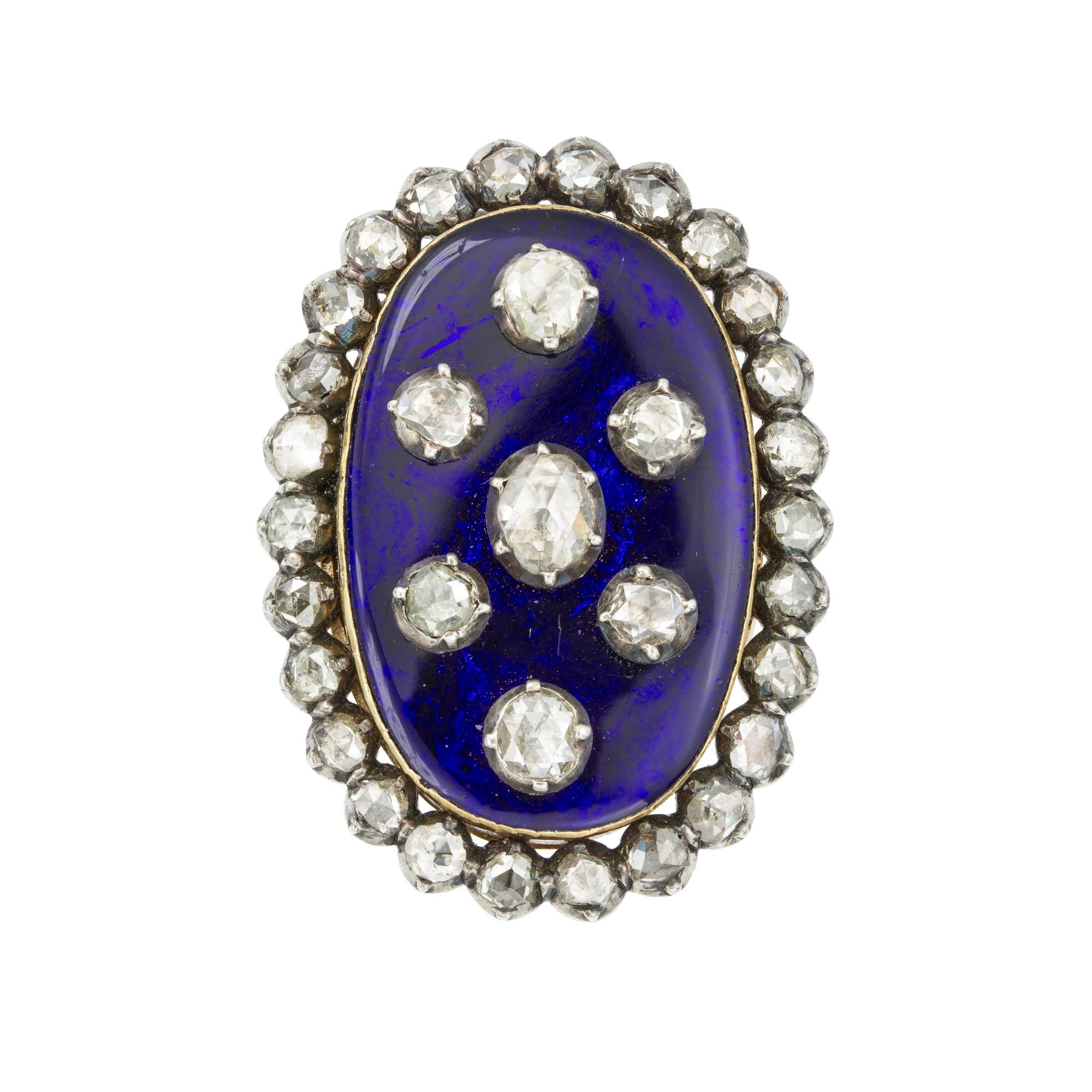 A Georgian blue enamel and diamond ring, the oval blue enamel set to the centre with an oval rose-cut diamond, surrounded by six round rose-cut diamonds  all diamonds cut-down silver collet-set on enamel, to a rose-cut diamond-set boarder, diamonds