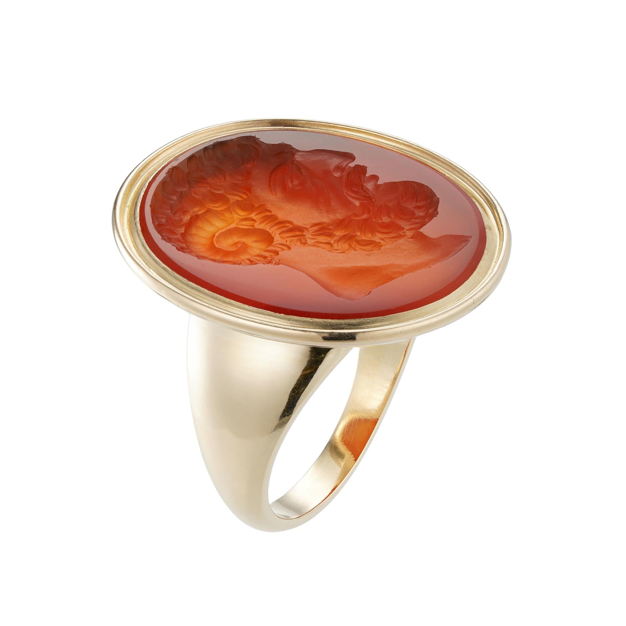 A Georgian carnelian intaglio ring, the oval carnelian measuring 20 x 17mm, seal engraved with the head of Zeus Ammon, depicted in profile with ram’s horn, set in yellow gold mount with an open back and tapering gold shoulders, unmarked, tested as