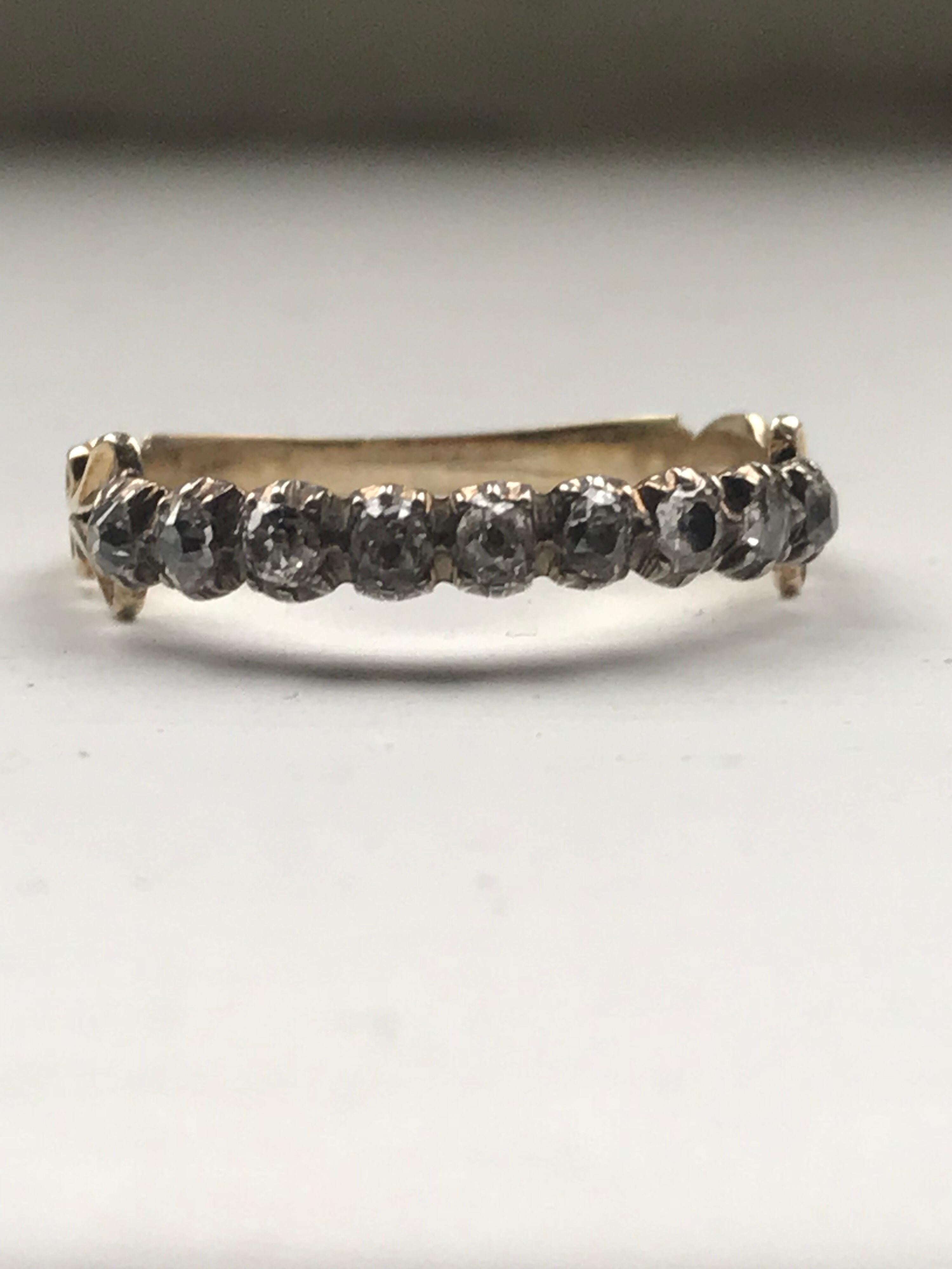 A diamond Georgian antique eternity band set with a row of rose cuts in silver with an 18k scrolled shank which is in excellent original condition. 