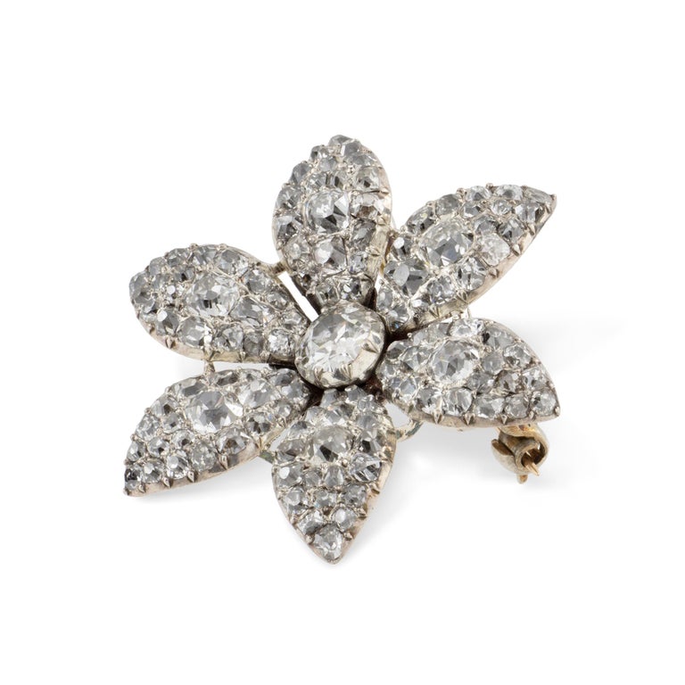 A Georgian diamond set jasmine flower brooch, to the centre set with old brilliant-cut diamond estimated to weigh 0.85 carats, surrounded by six petals set throughout with old-cut diamonds graduating from the centre and estimated to weigh a further
