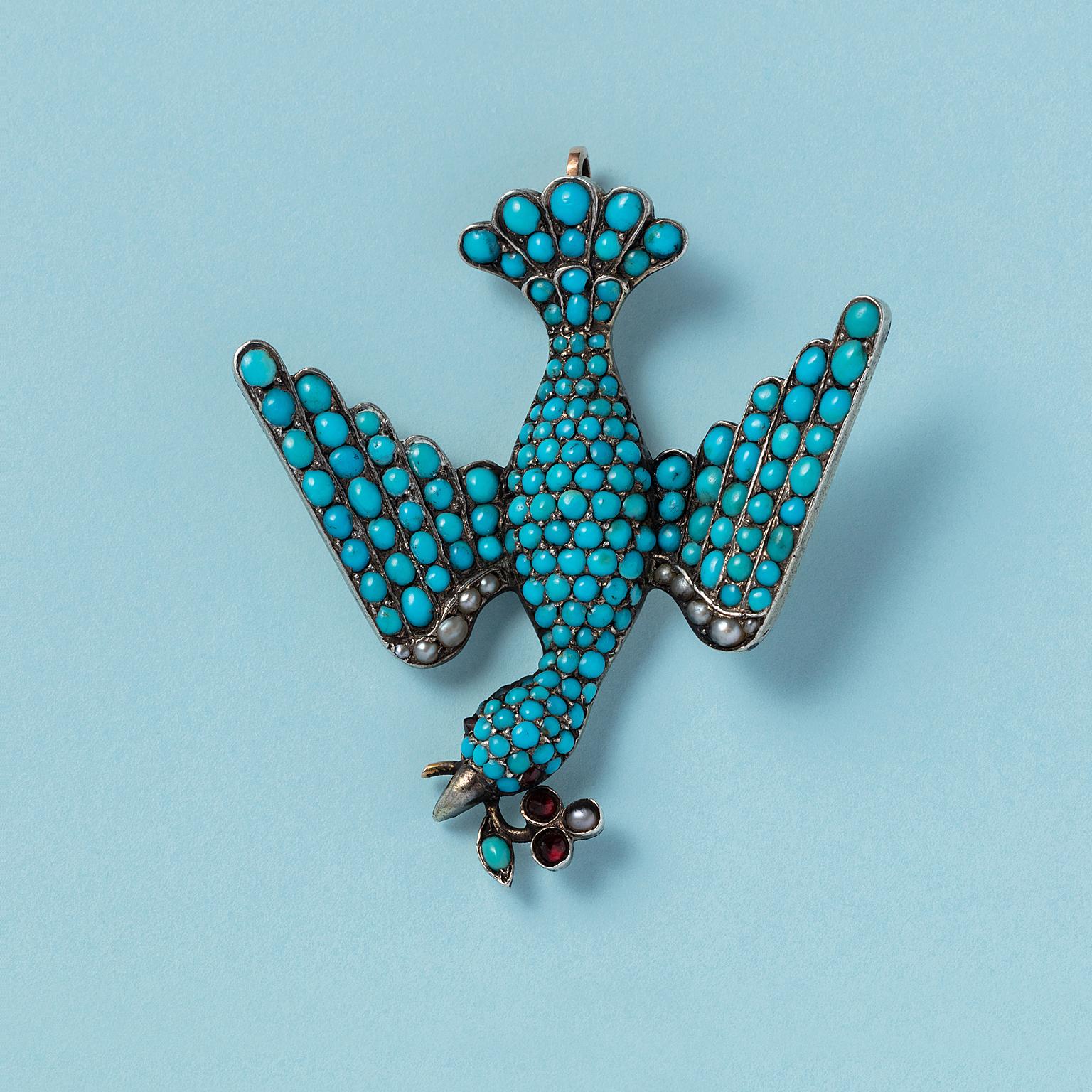 A large Georgian dove 9-carat gold pendant (brooch conversion). The bird is pavé-set with vibrant cabochon cut turquoise. It carries a stylized branch of garnets, pearl, and turquoise in its beak, England, circa 1820.

weight: 14.71 grams
length: