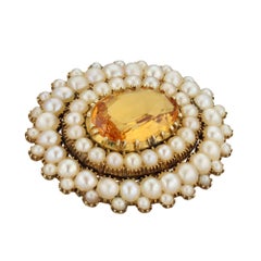 A Georgian golden topaz and pearl cluster brooch