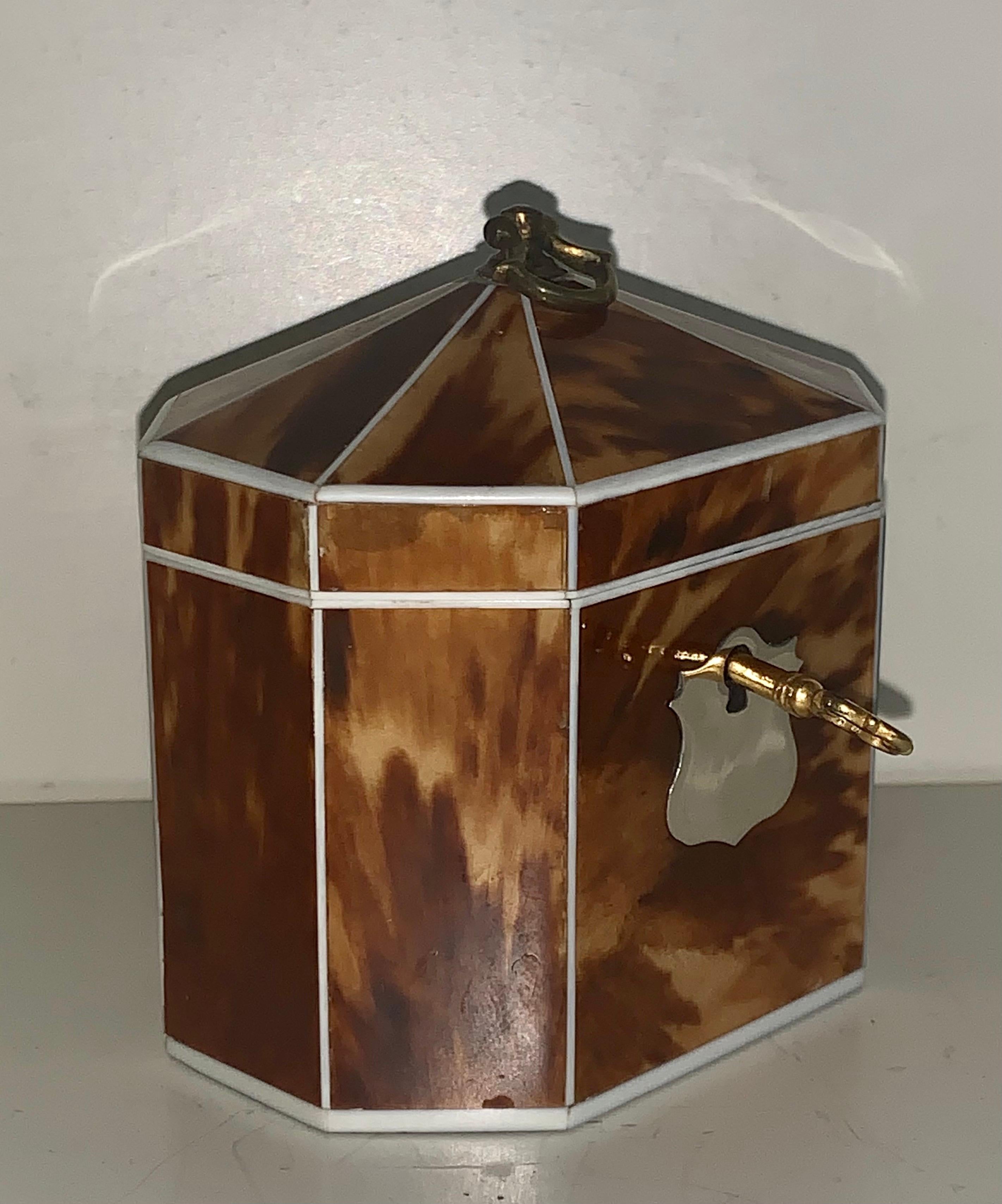 A Very elegant and rare blonde tortoiseshell tea caddy of decagonal form with silver metal shield shape escutcheon. The figuring of the blonde tortoiseshell is well matched throughout. This entire hand crafted caddy with a tent top form lid has a