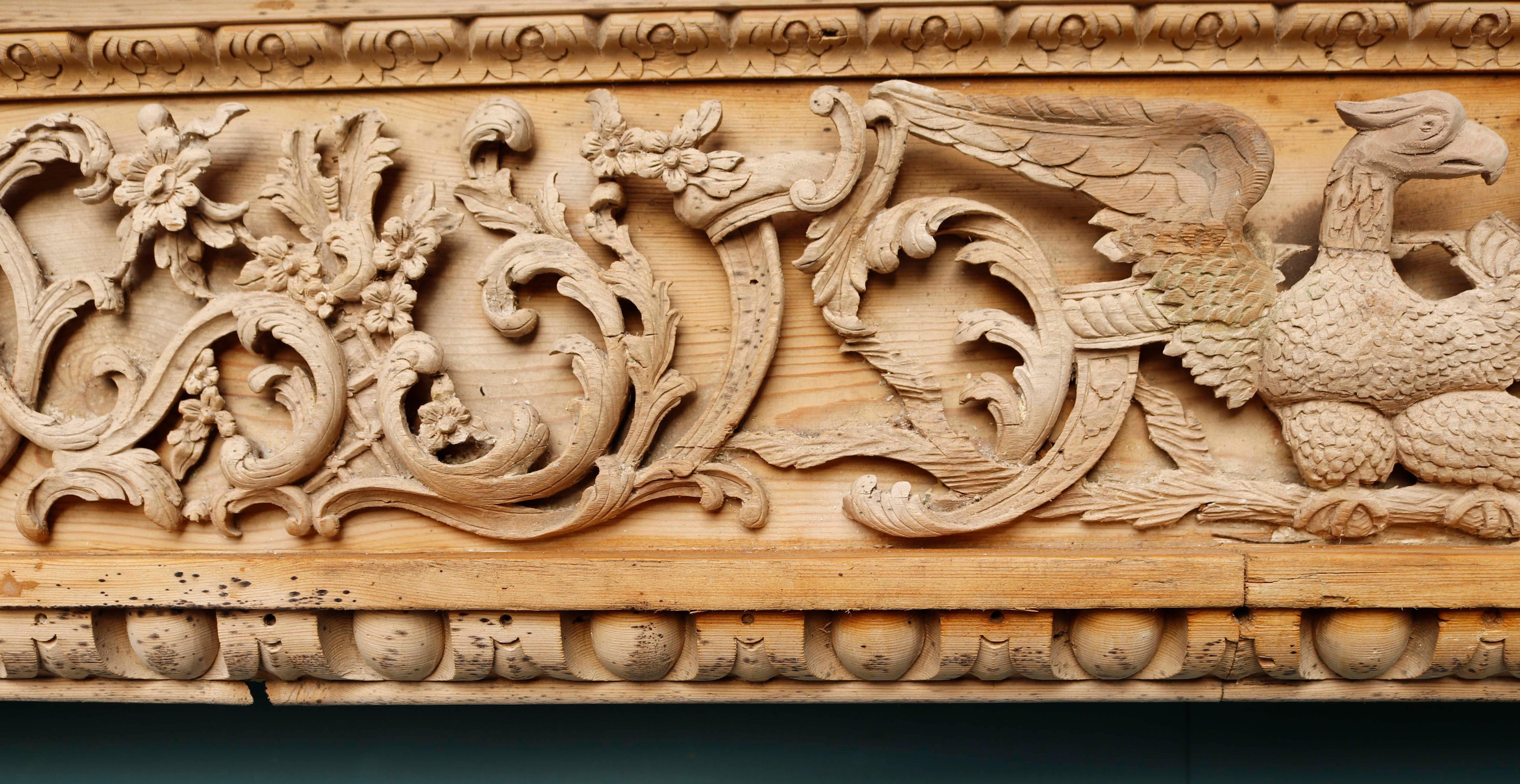 Antique Georgian Period Carved Fireplace. A rare English George III period carved pine fireplace. The frieze is deeply carved with foliage and centred with an eagle.

Additional dimensions

Opening height 119 cm

Opening width 121 cm

Width